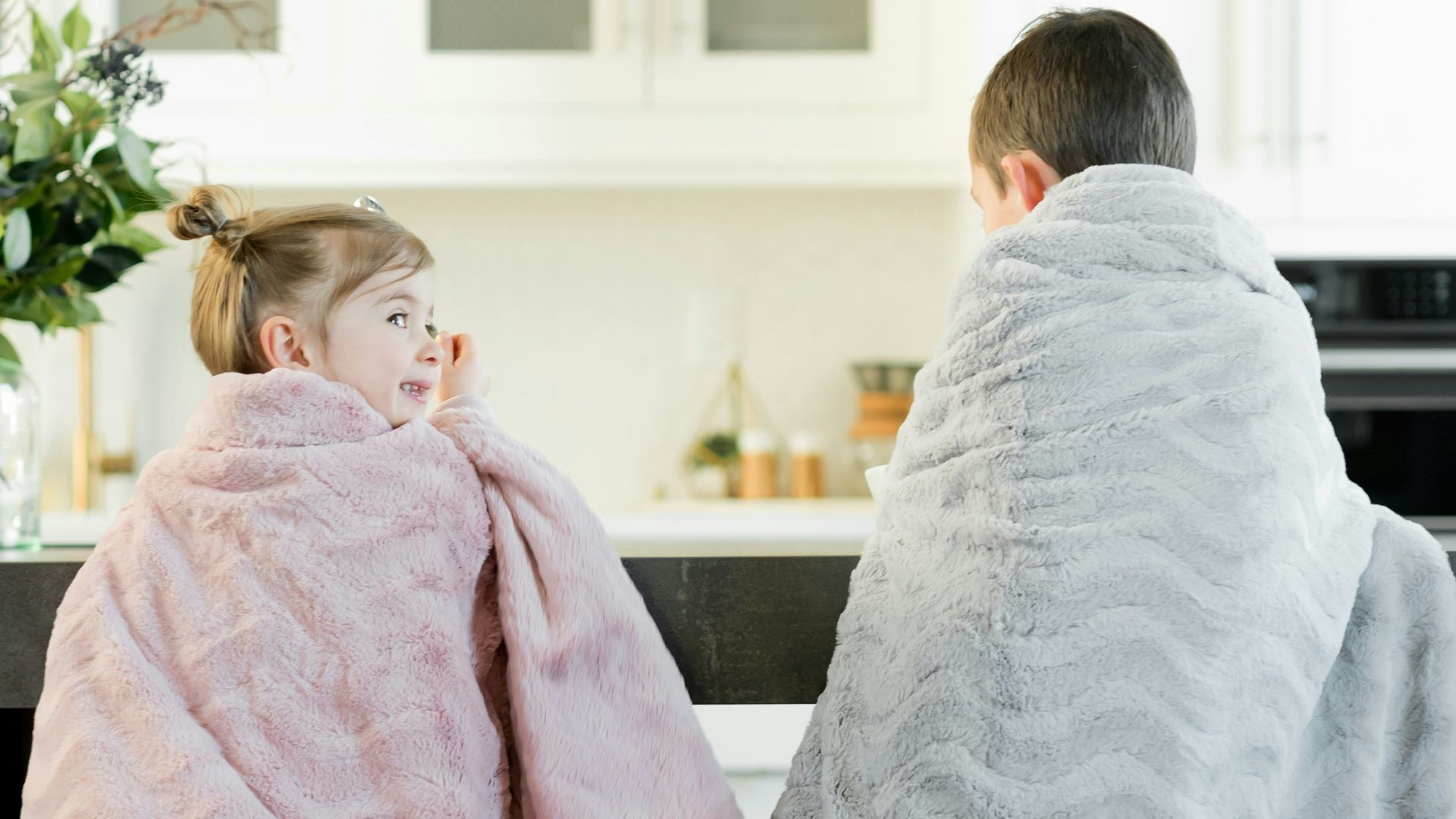 two children sitting in front of table