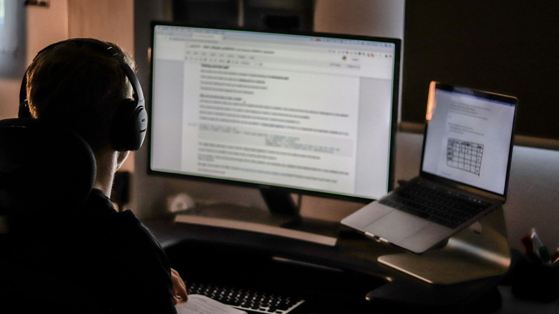 man using laptop computer and headphones