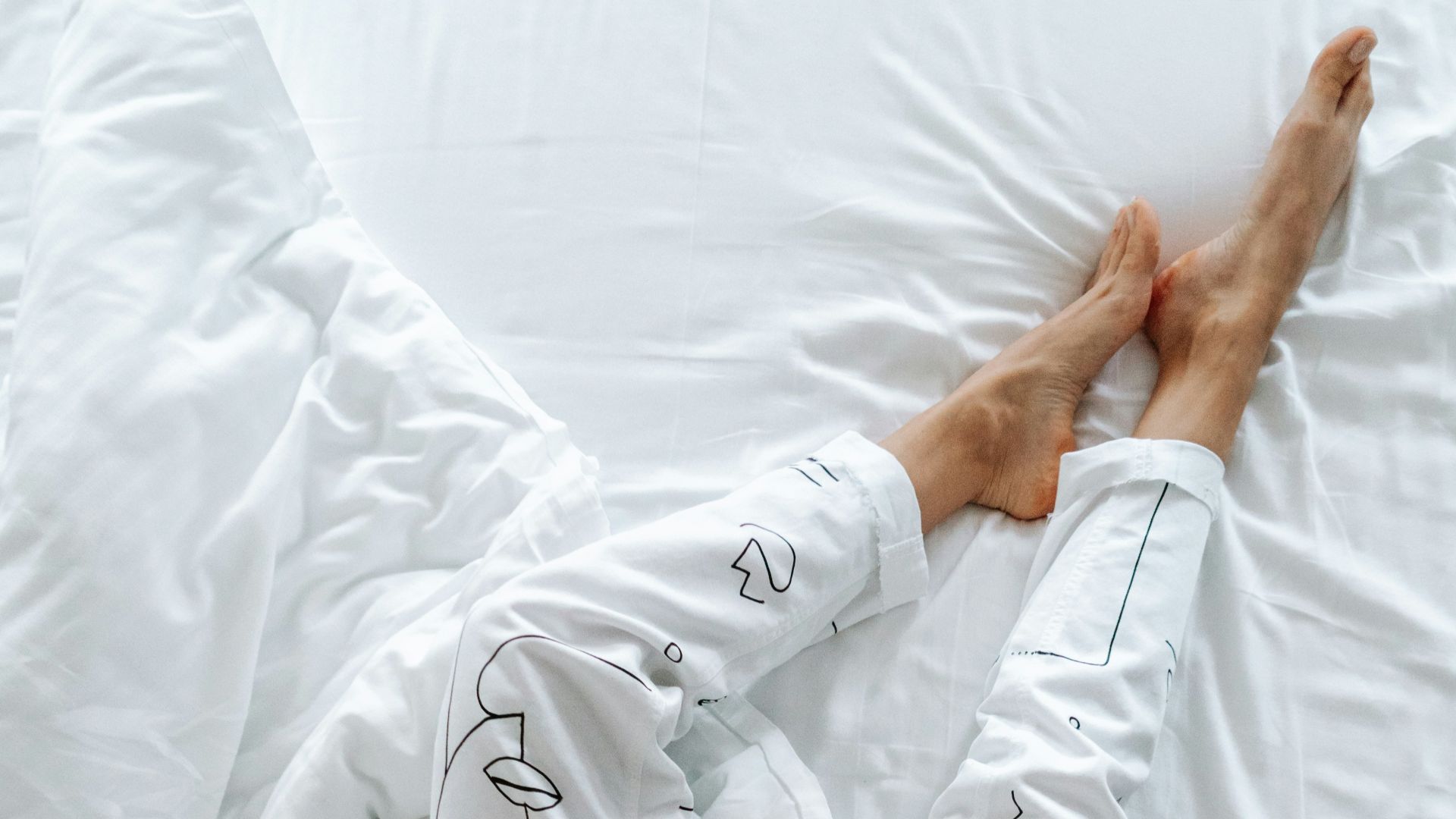 person in white robe holding white textile