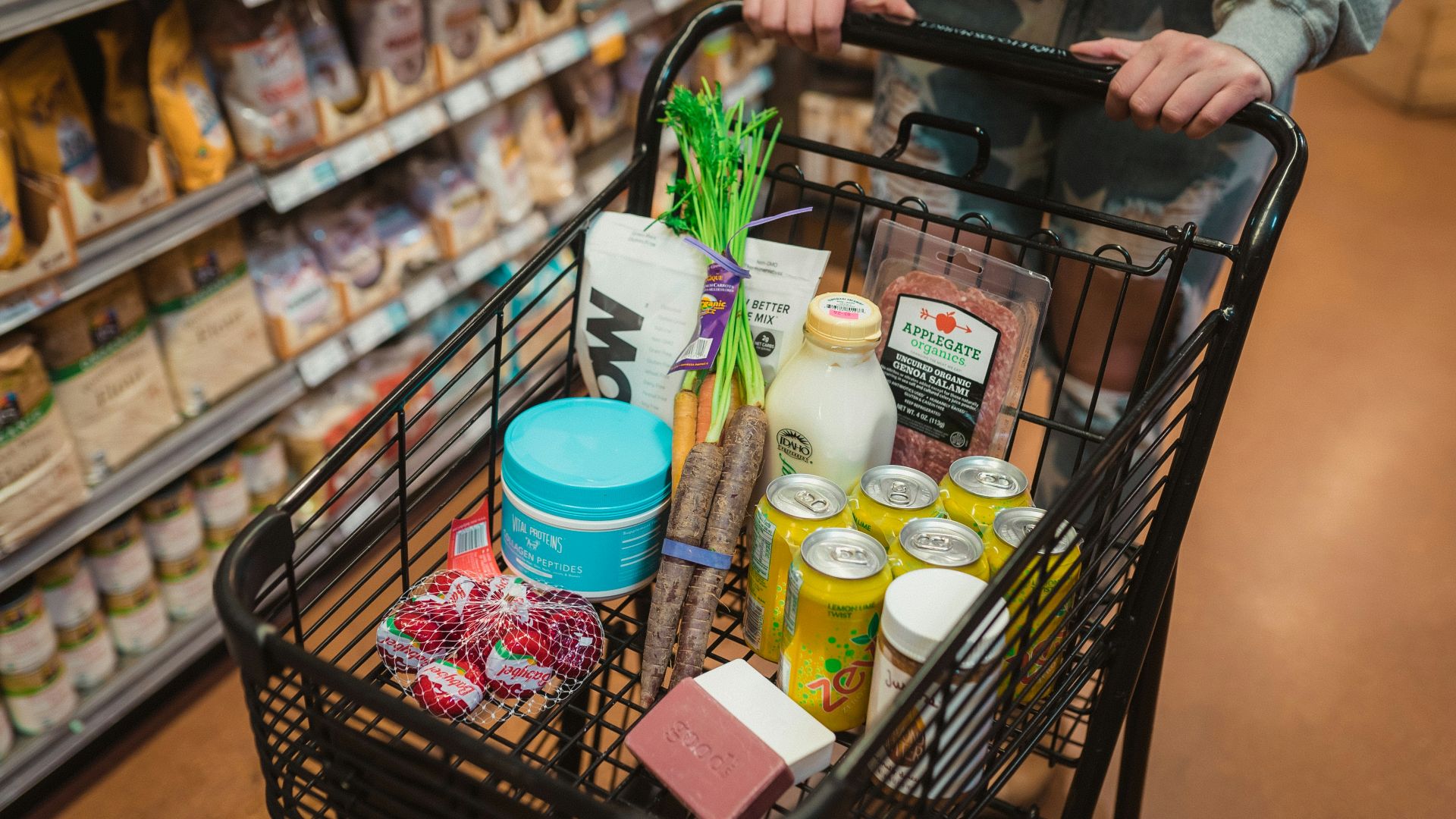 a person pushing a shopping cart full of food