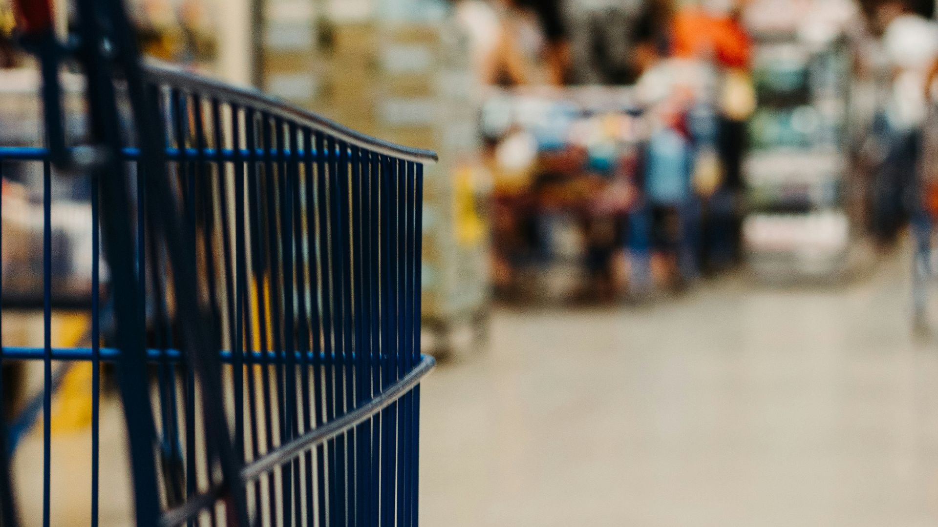 blue shopping cart on street during daytime