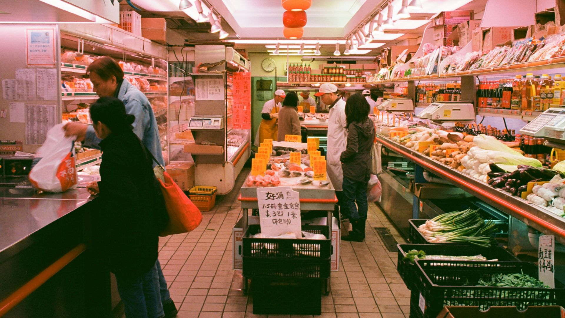 man stands beside man in front of cashier in store