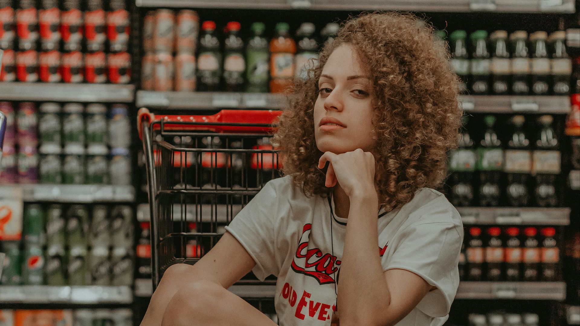 woman sitting in shopping cart