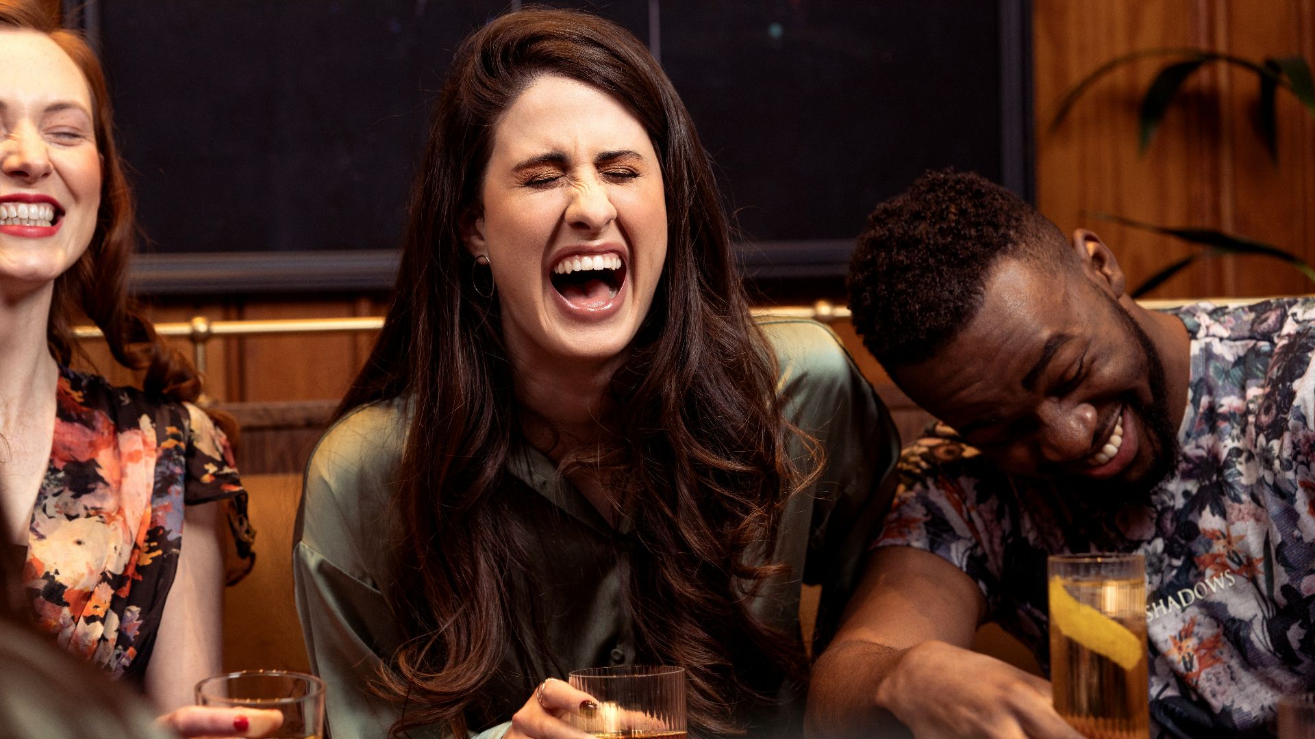 a group of people sitting around a table with drinks