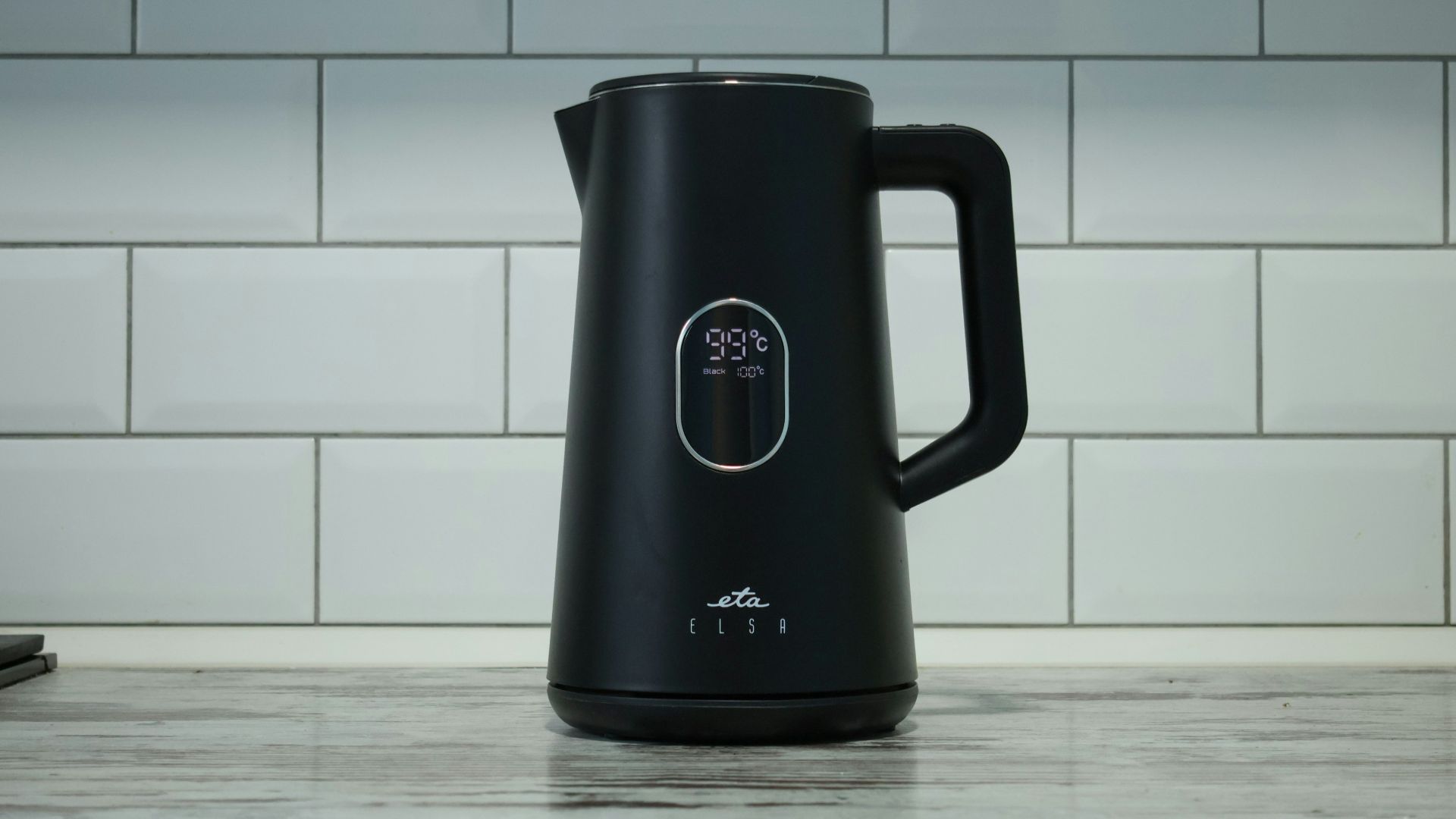 A black coffee pot sitting on top of a counter