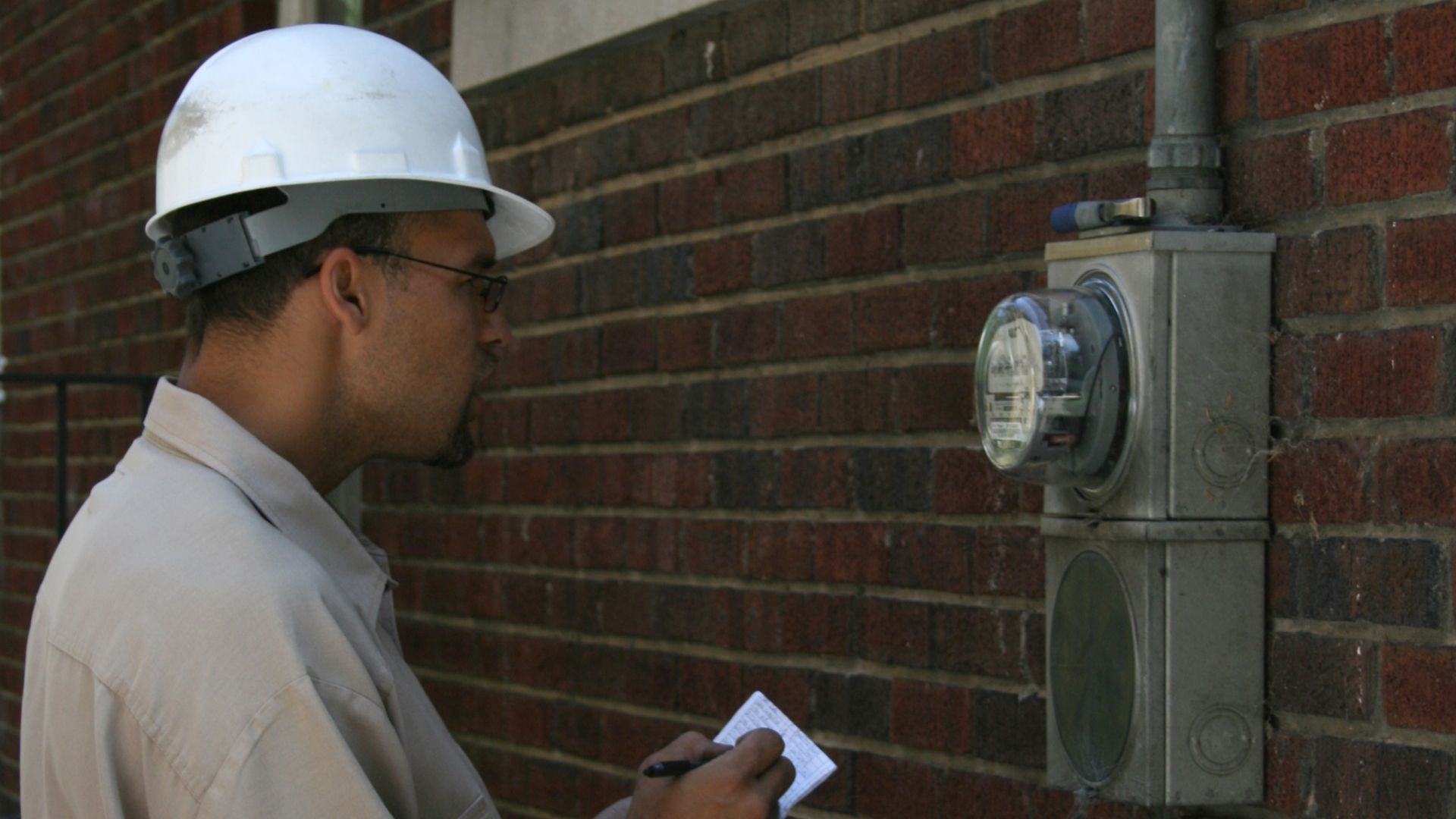 File:2008-08-12 Technician reading electricity meter at a residence.jpg