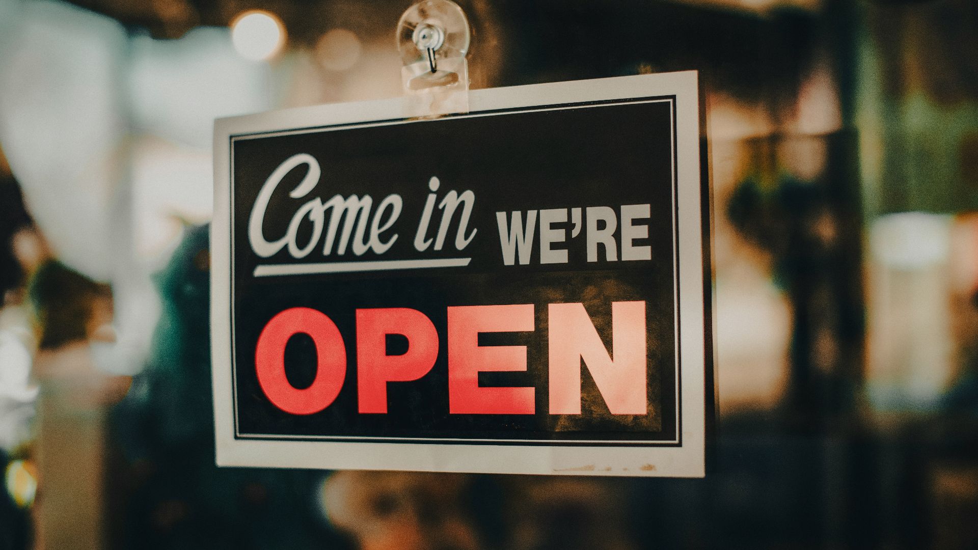 a sign that says come in we're open