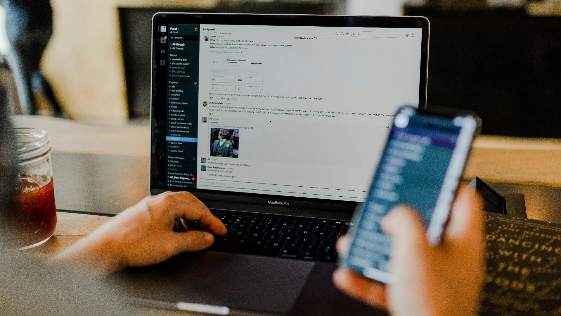 person using phone and laptop