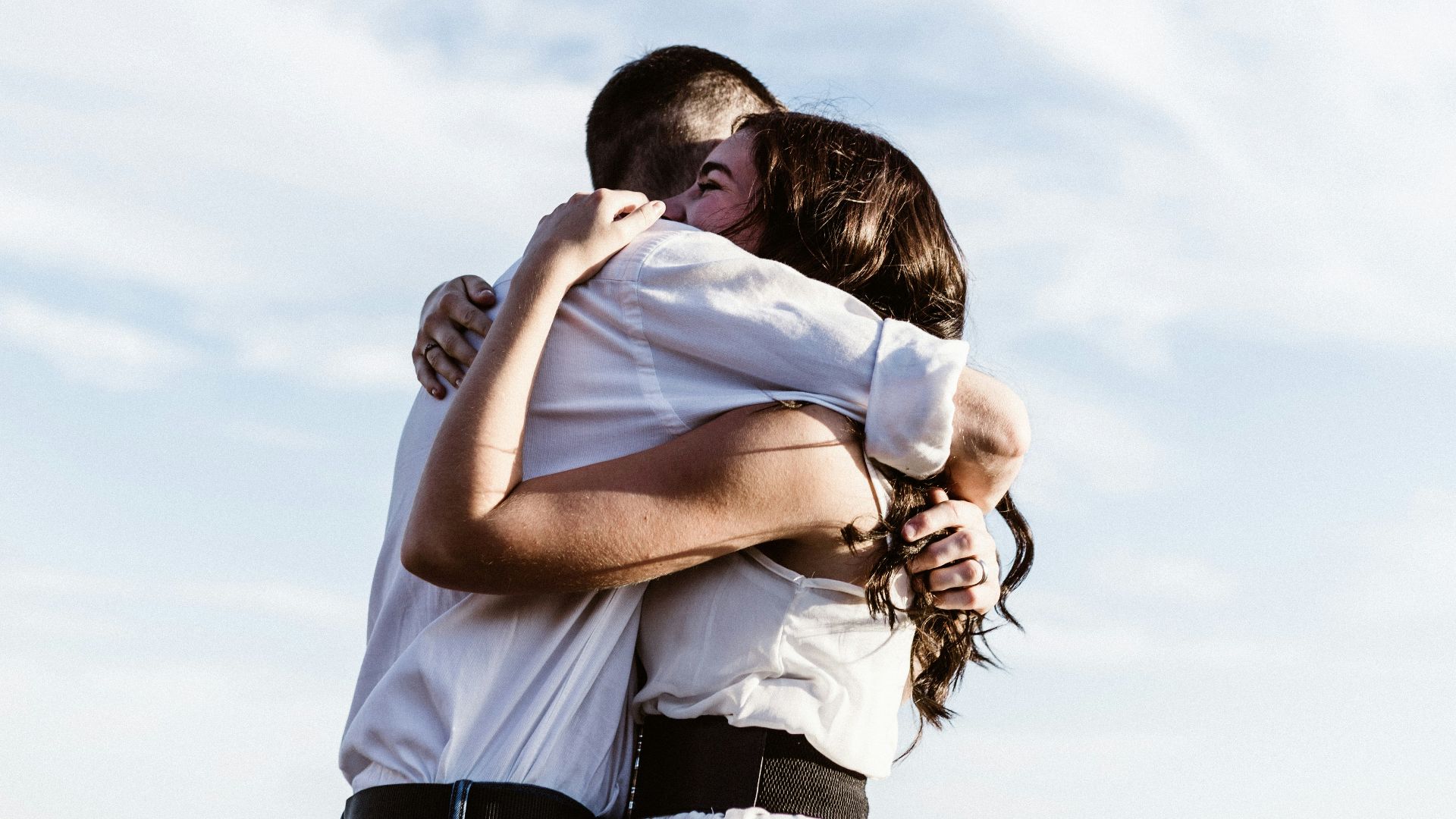 man and woman hugging each other photography