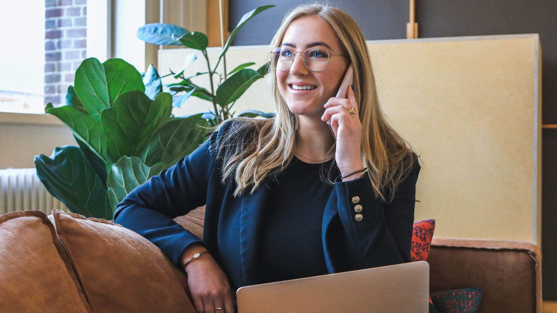 woman in blue long sleeve shirt using silver macbook