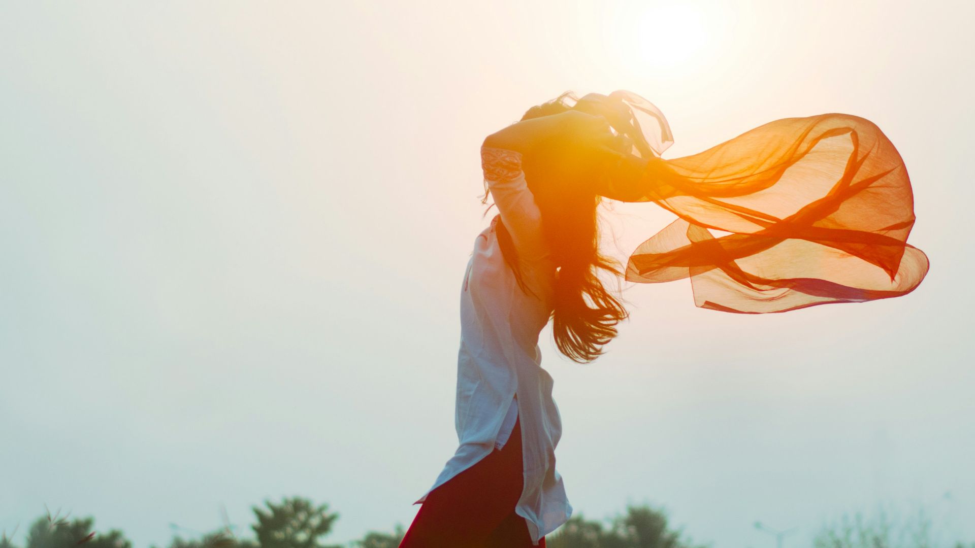 woman spreading hair at during sunset