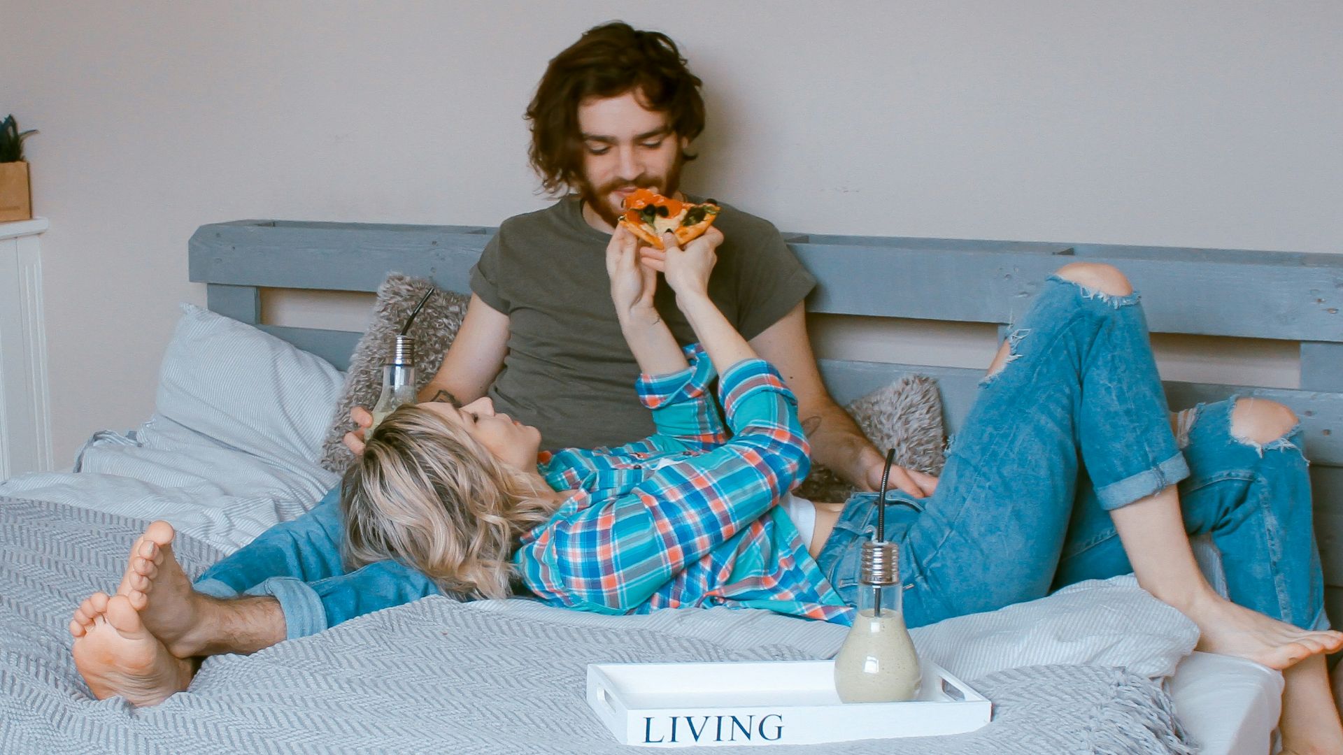 man and woman lying on bed