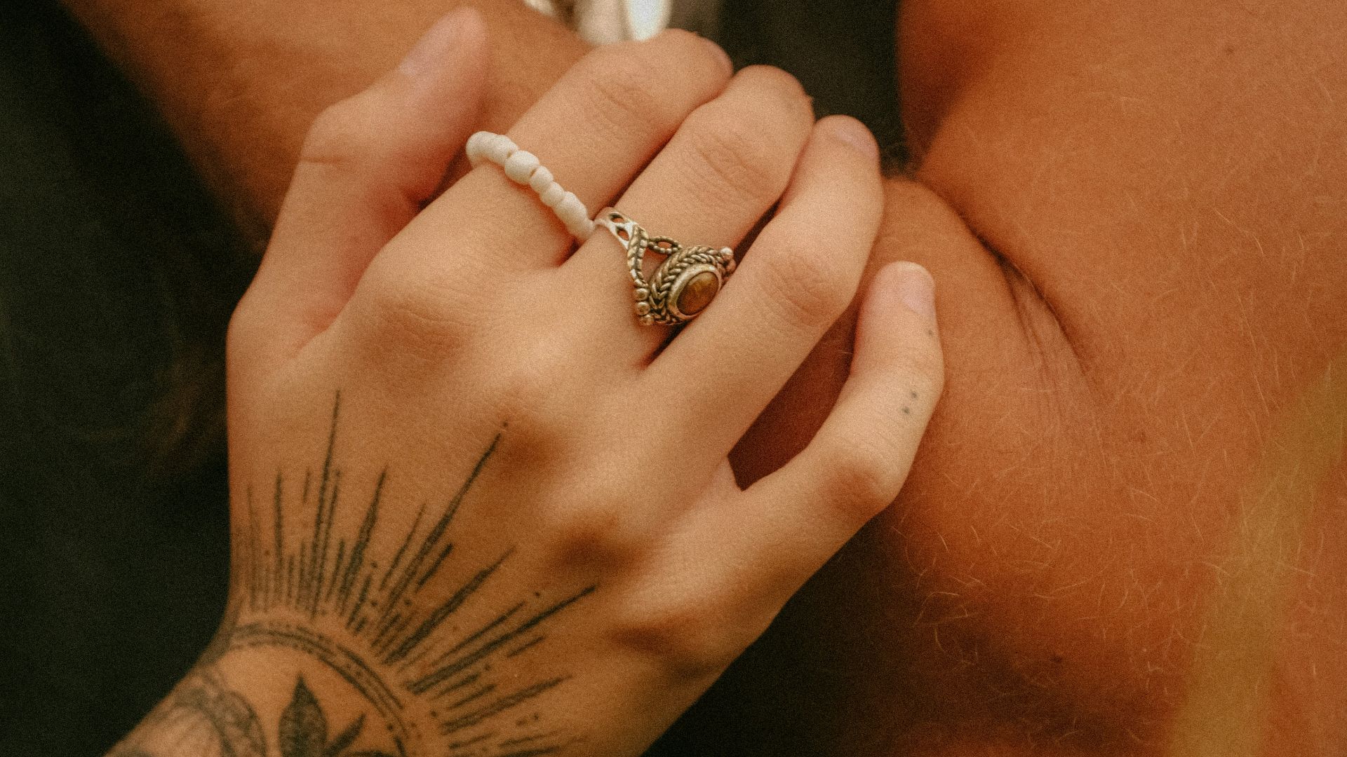 a close up of a person holding a woman's hand