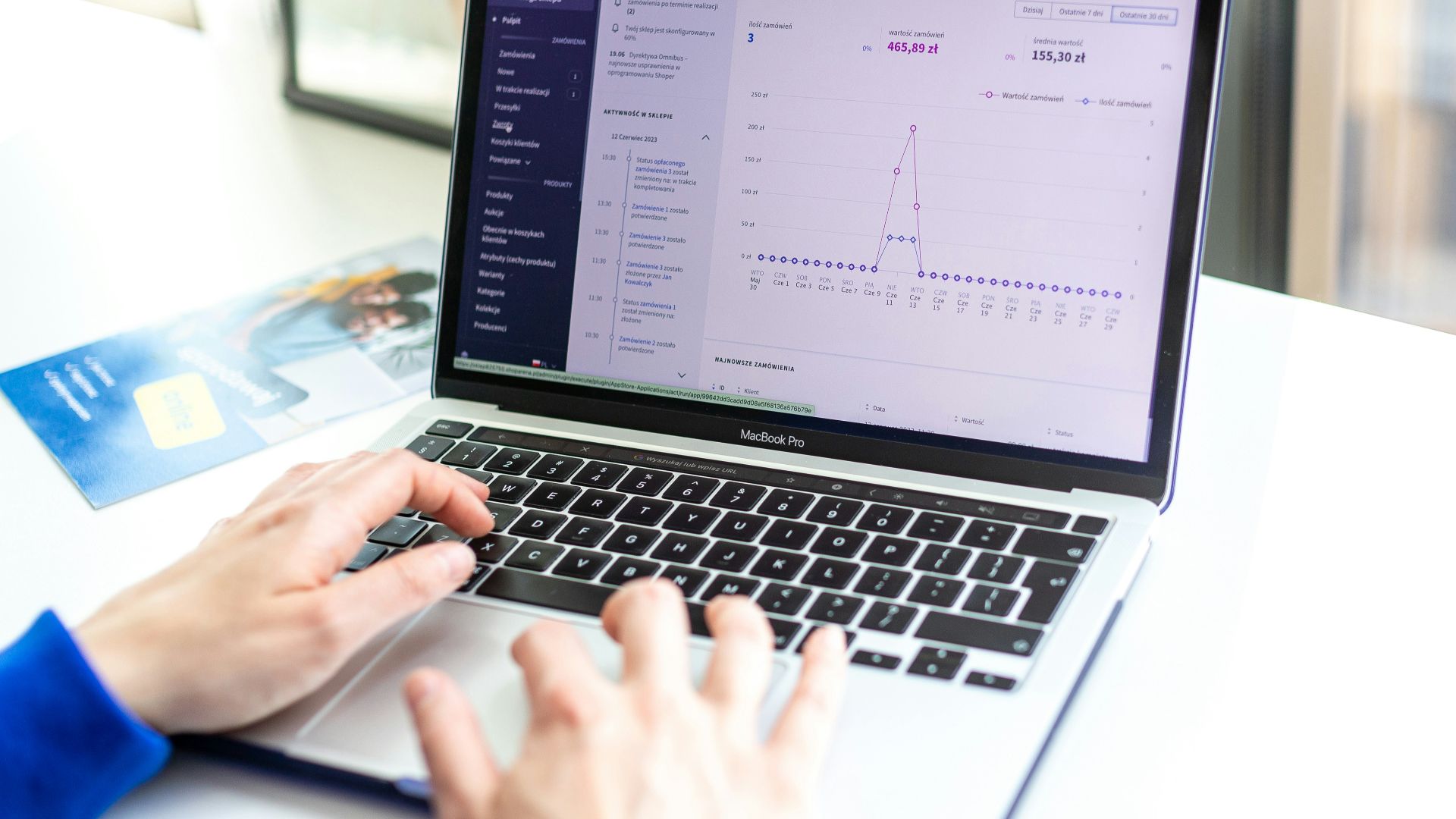 a person typing on a laptop computer on a desk
