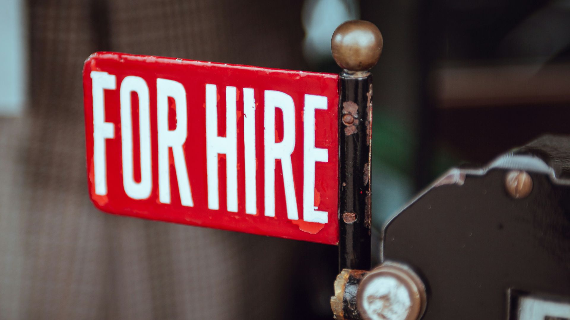 shallow focus photography of red and white for hire signage
