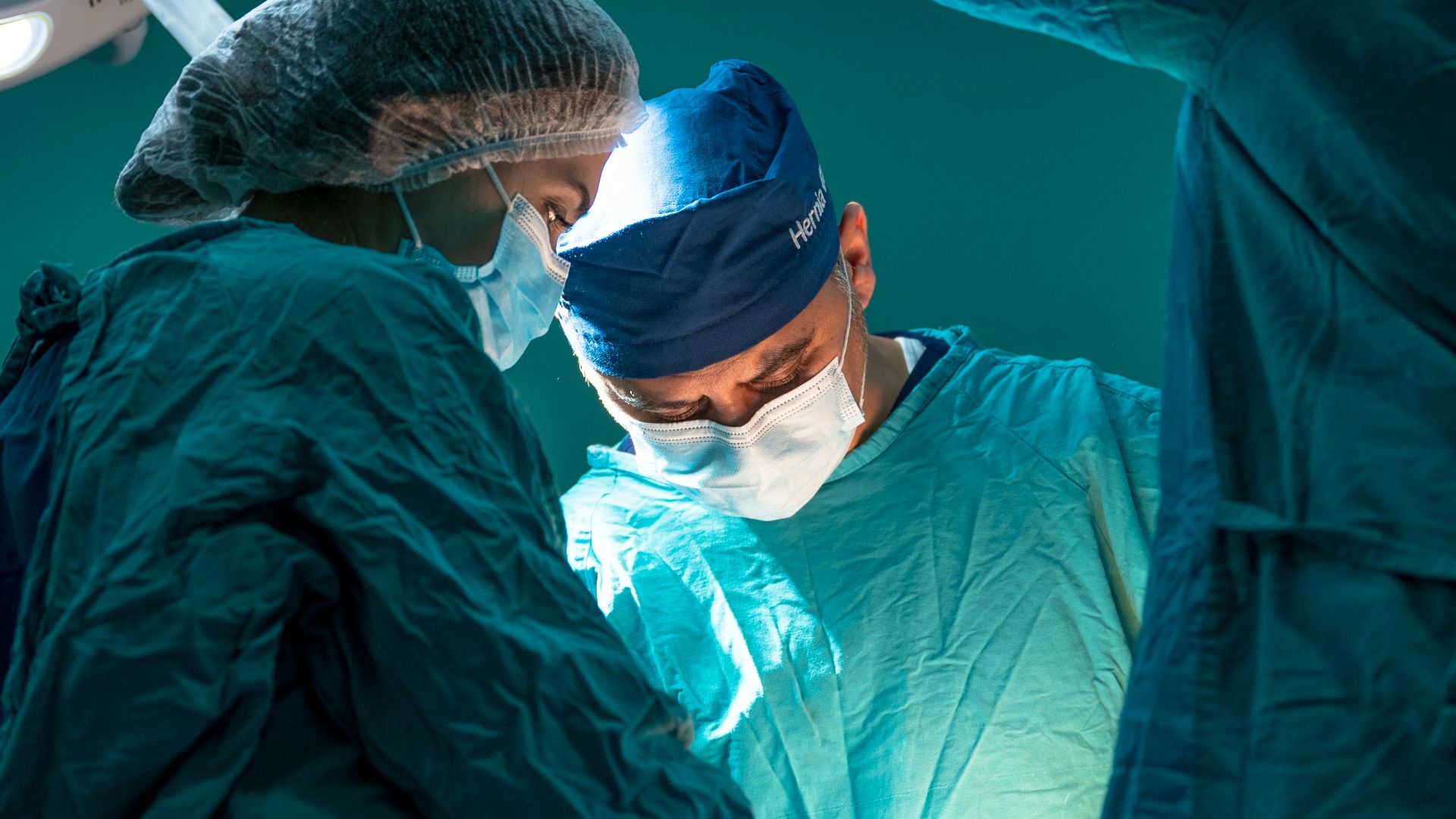 a group of doctors performing surgery on a patient