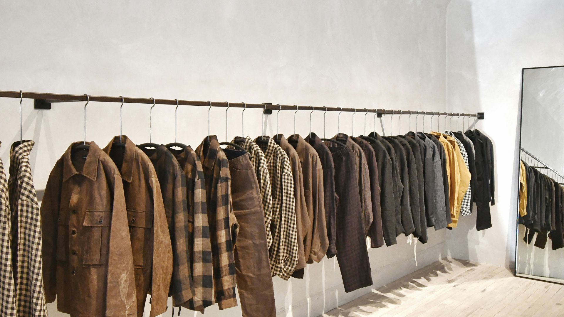 a room with a wall of clothes on the wall