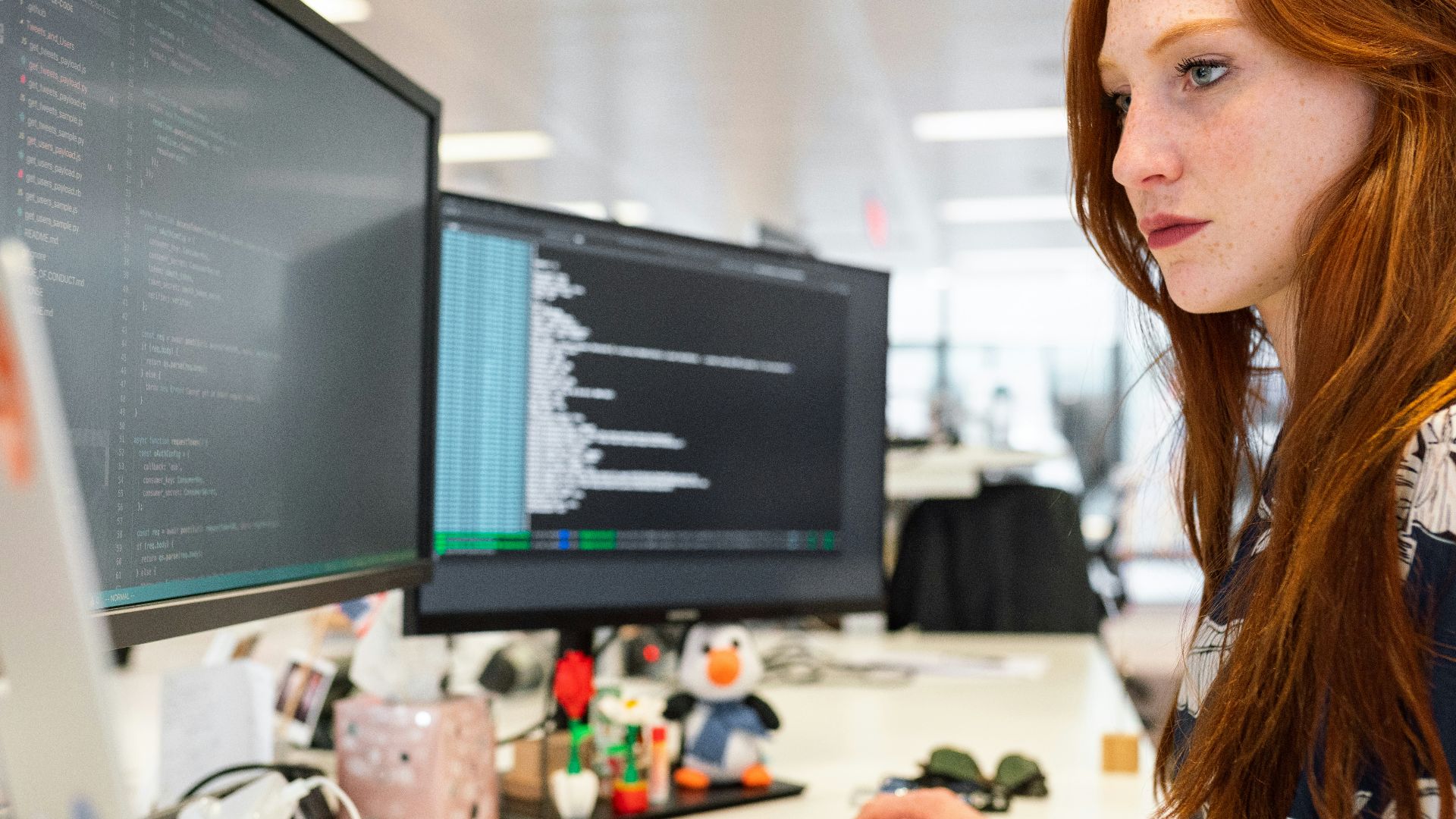 woman in green shirt sitting in front of computer
