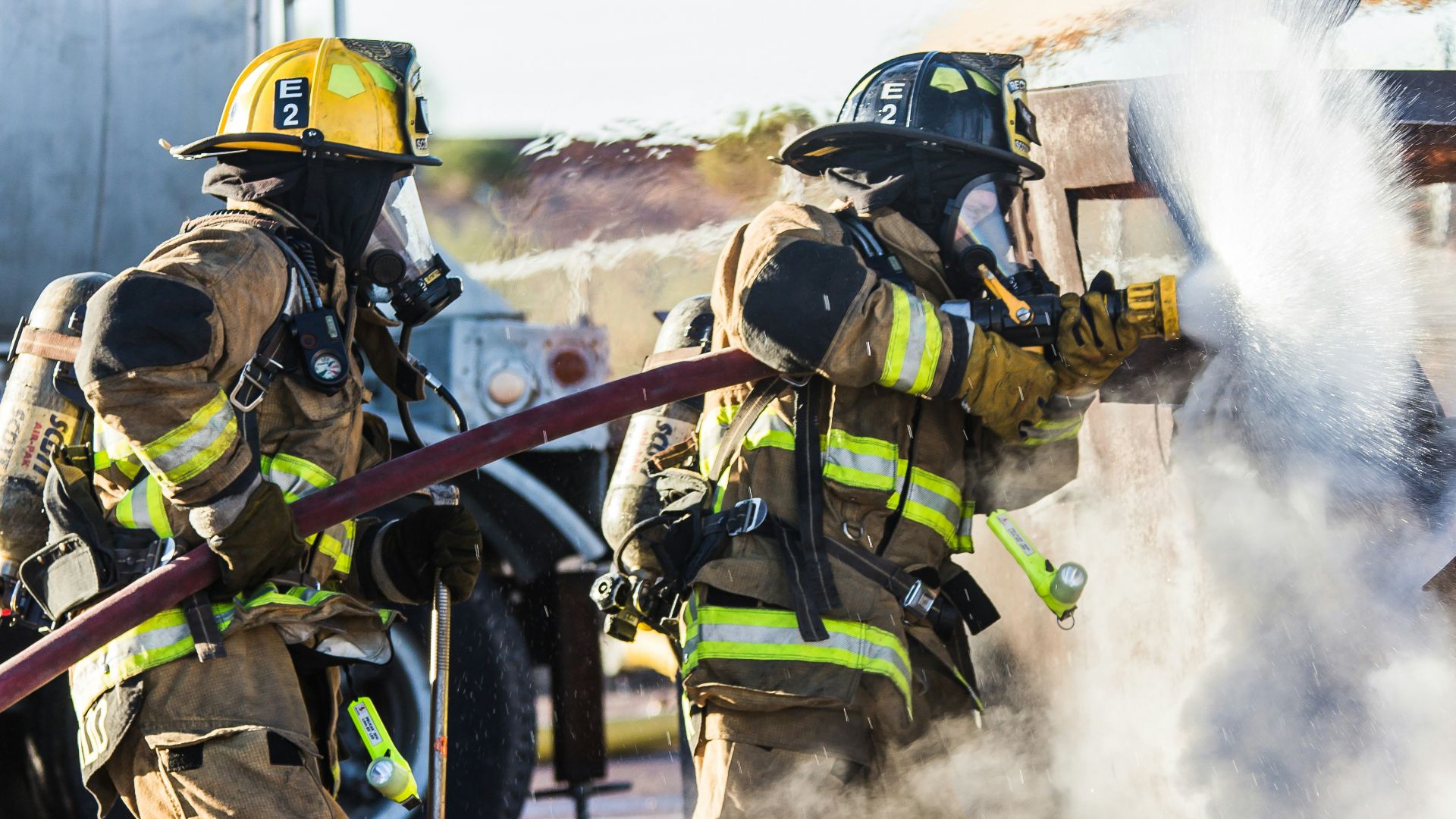 three fireman preventing fire during daytime