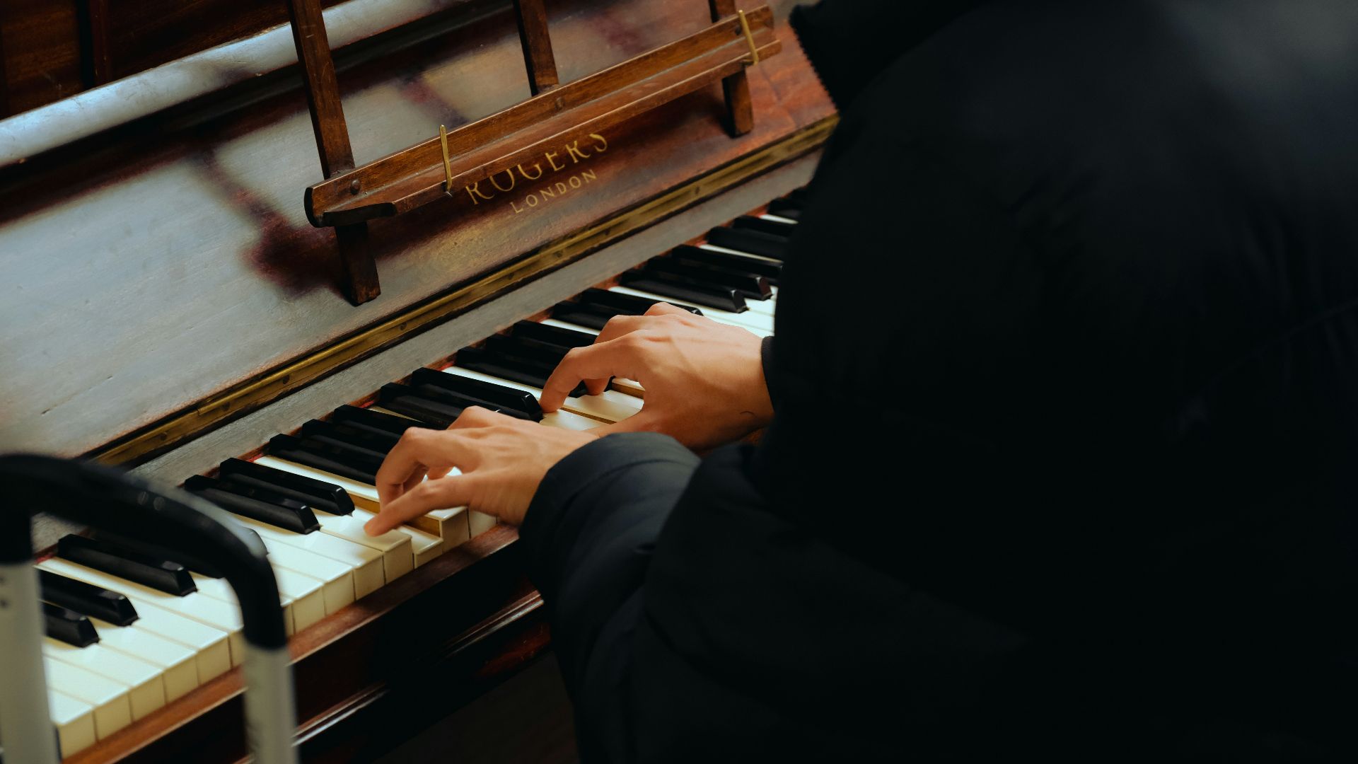 a person sitting at a piano playing a musical instrument