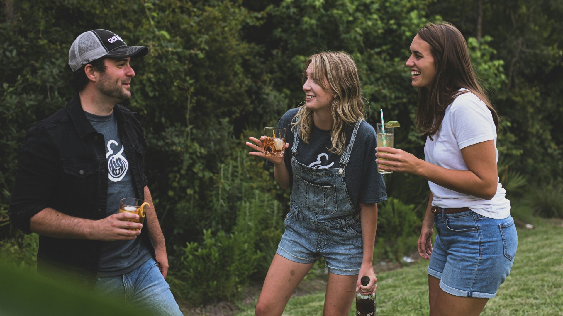 woman in black crew neck t-shirt and blue denim shorts standing beside woman in white