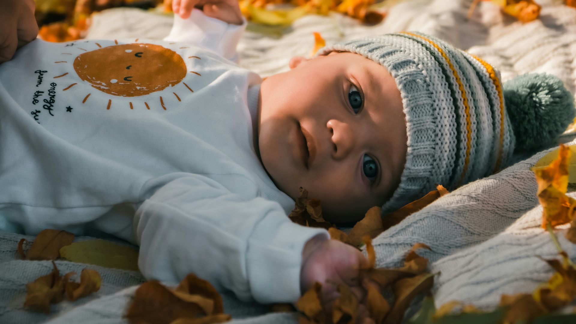 a baby lying on a blanket