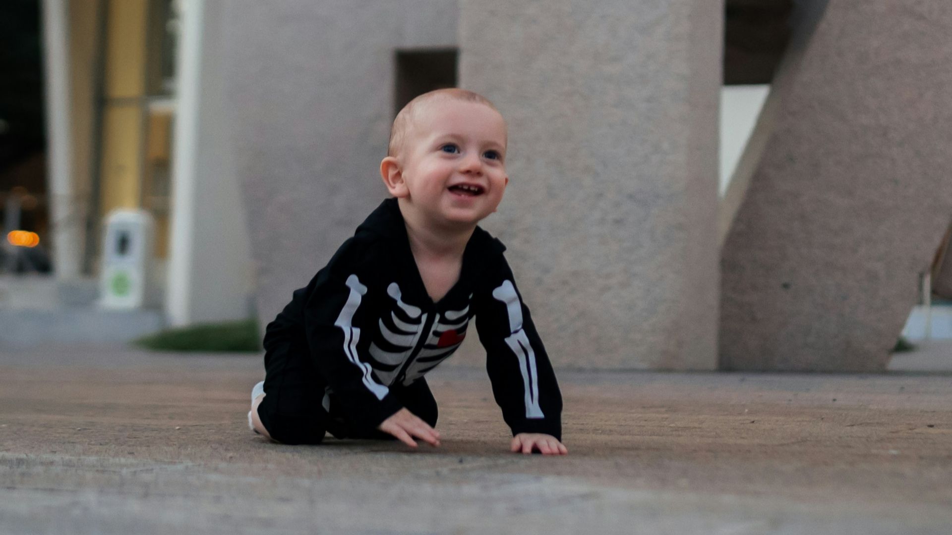 a baby crawling on a concrete surface