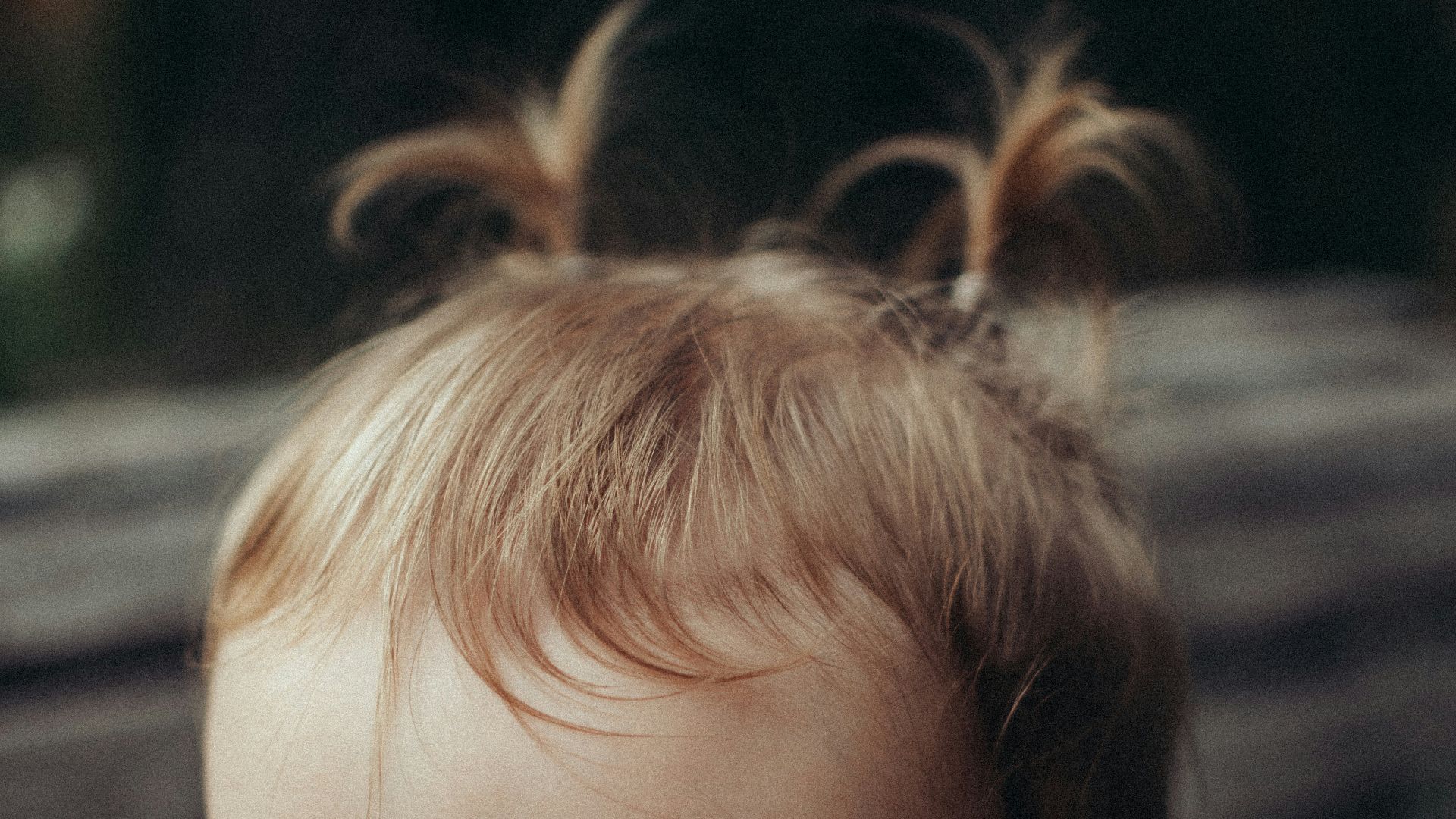 a baby with a ponytail