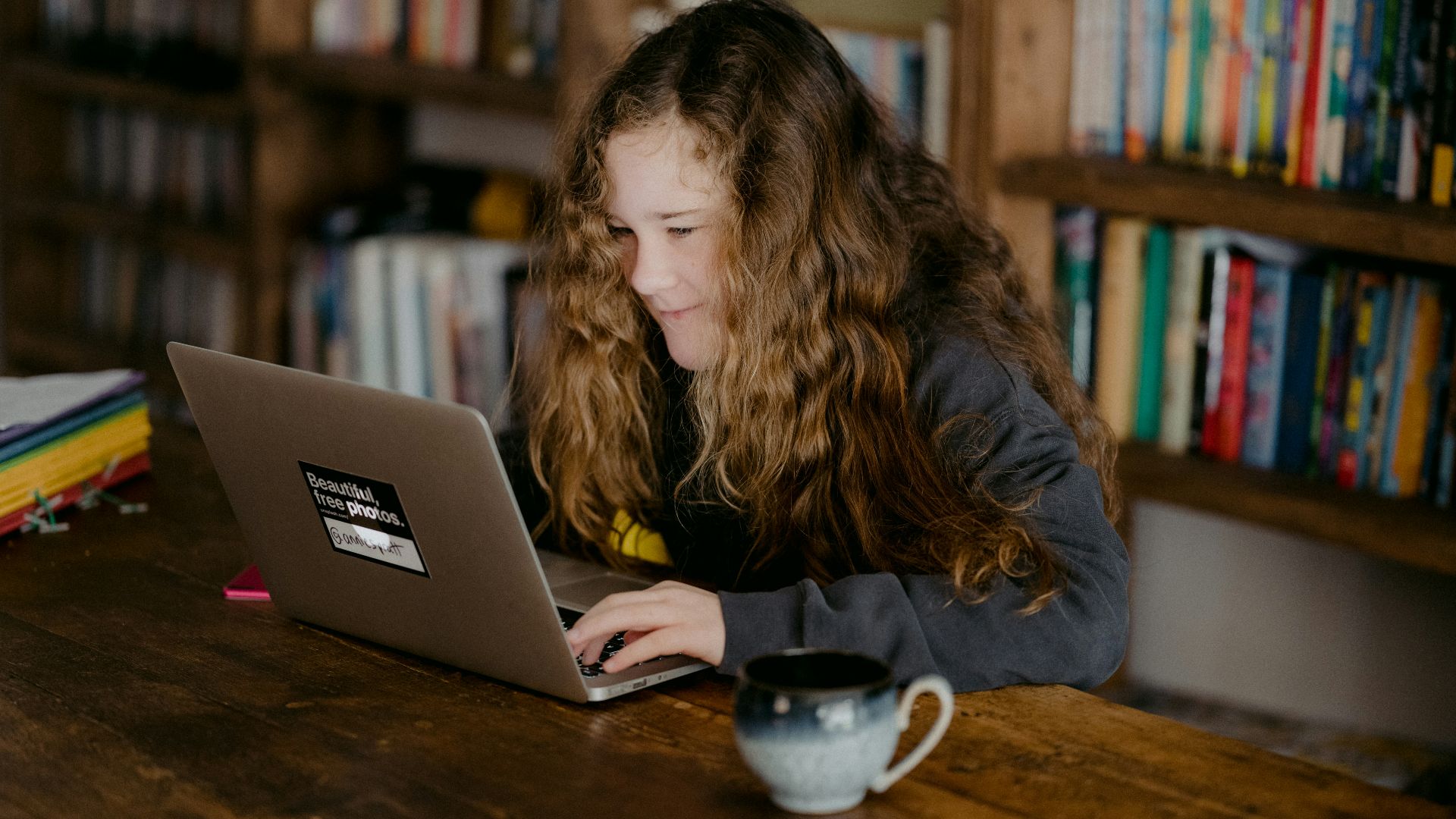 woman in black jacket using macbook pro