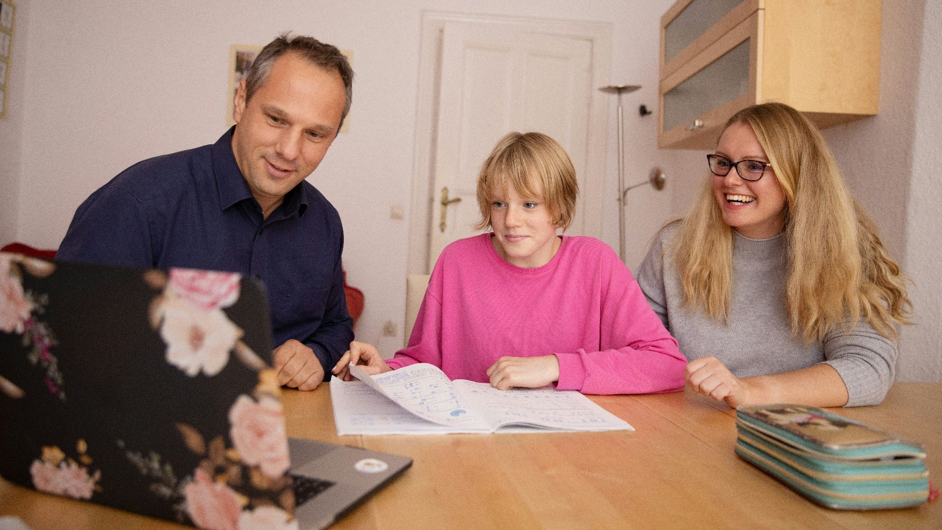 woman in blue shirt beside girl in pink shirt