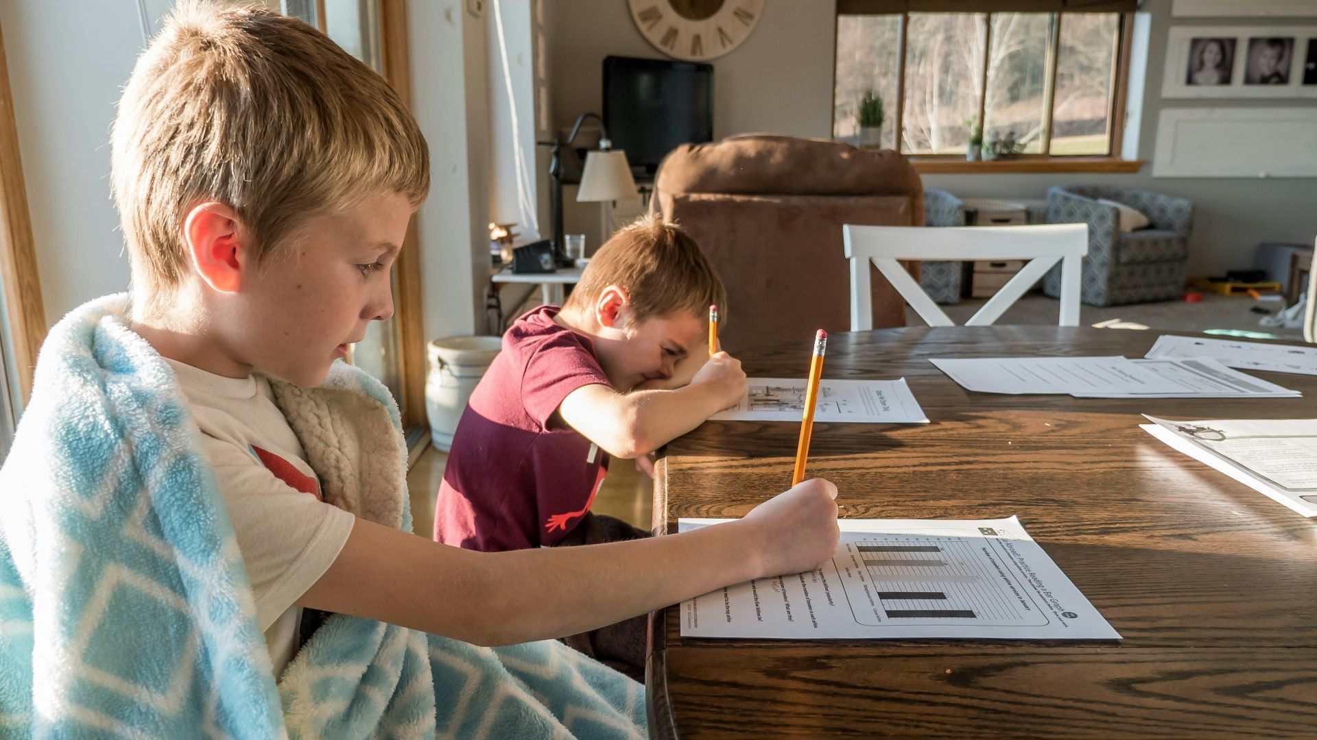boy in gray crew neck t-shirt reading book