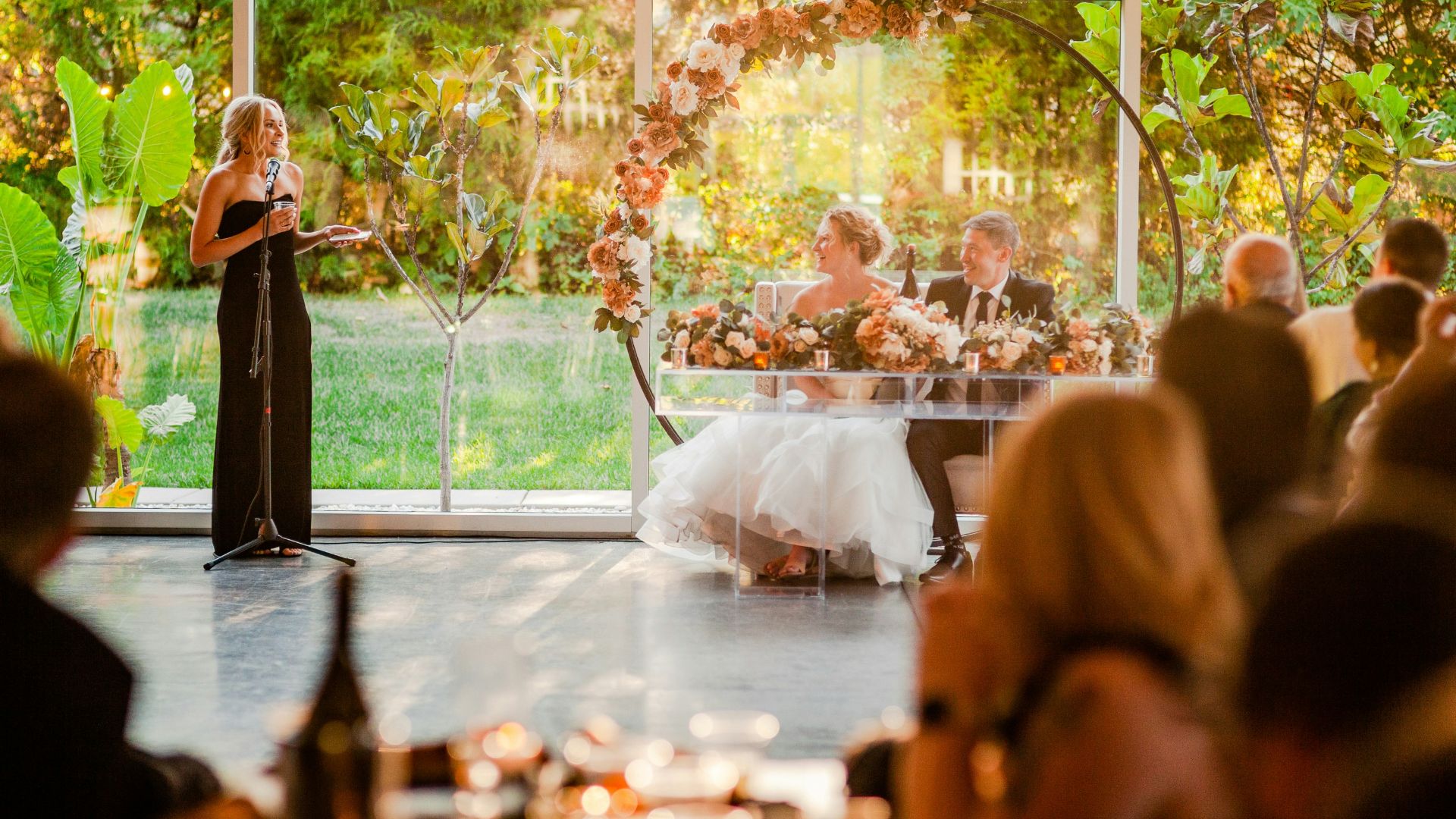 a woman standing at a podium in front of a crowd