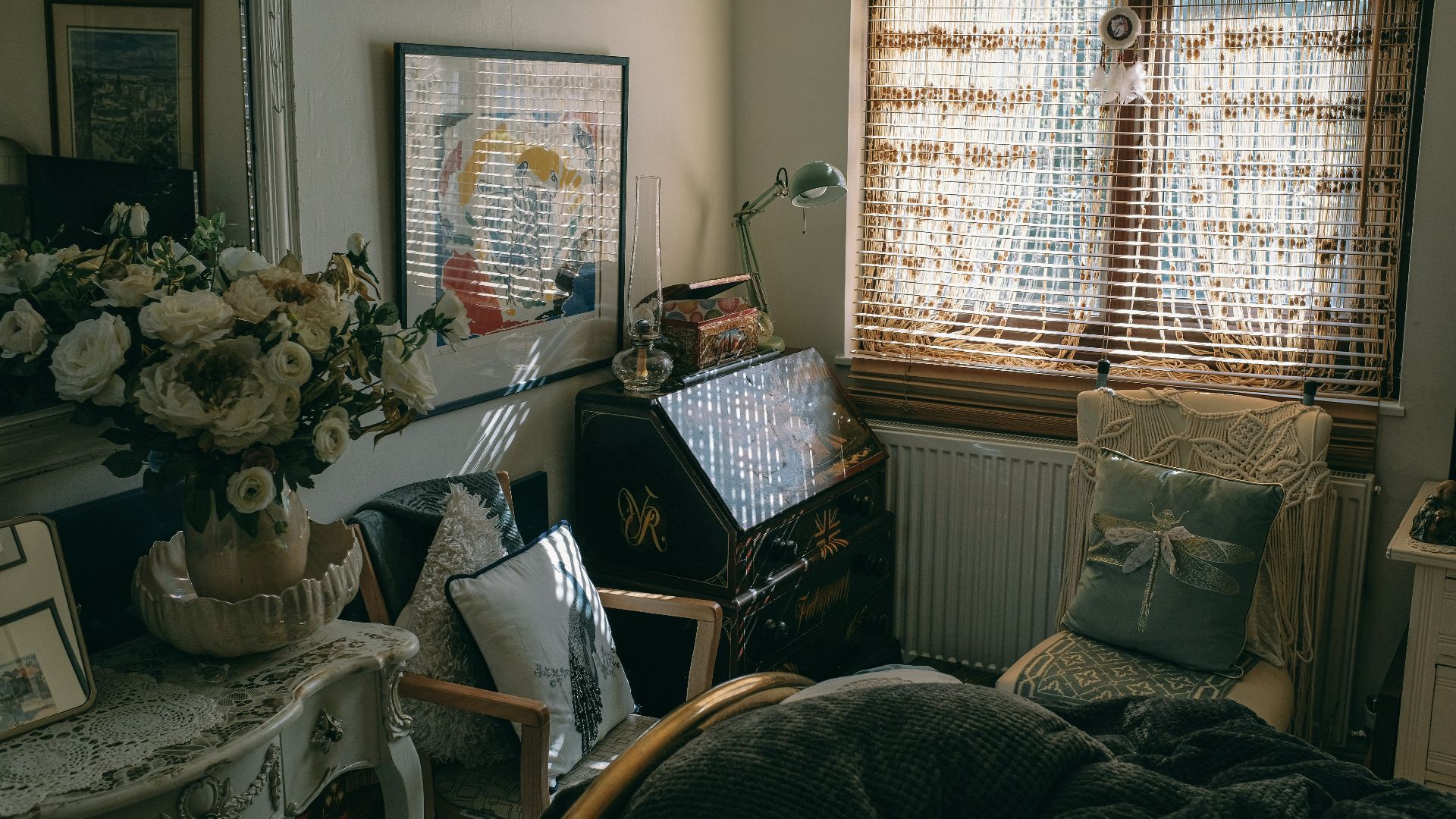 a bedroom with a bed and a desk with a laptop on it