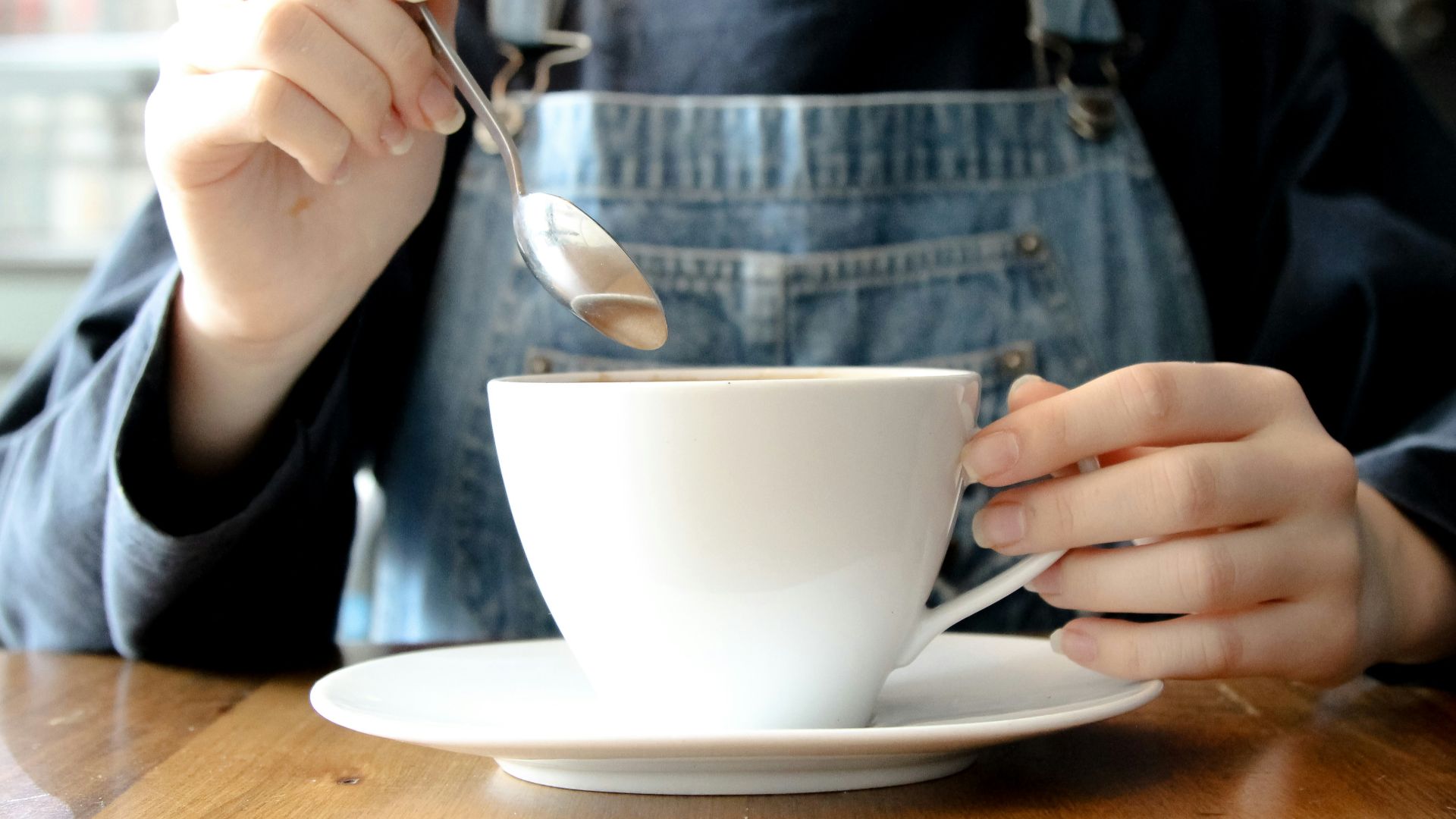 person having coffee during daytime