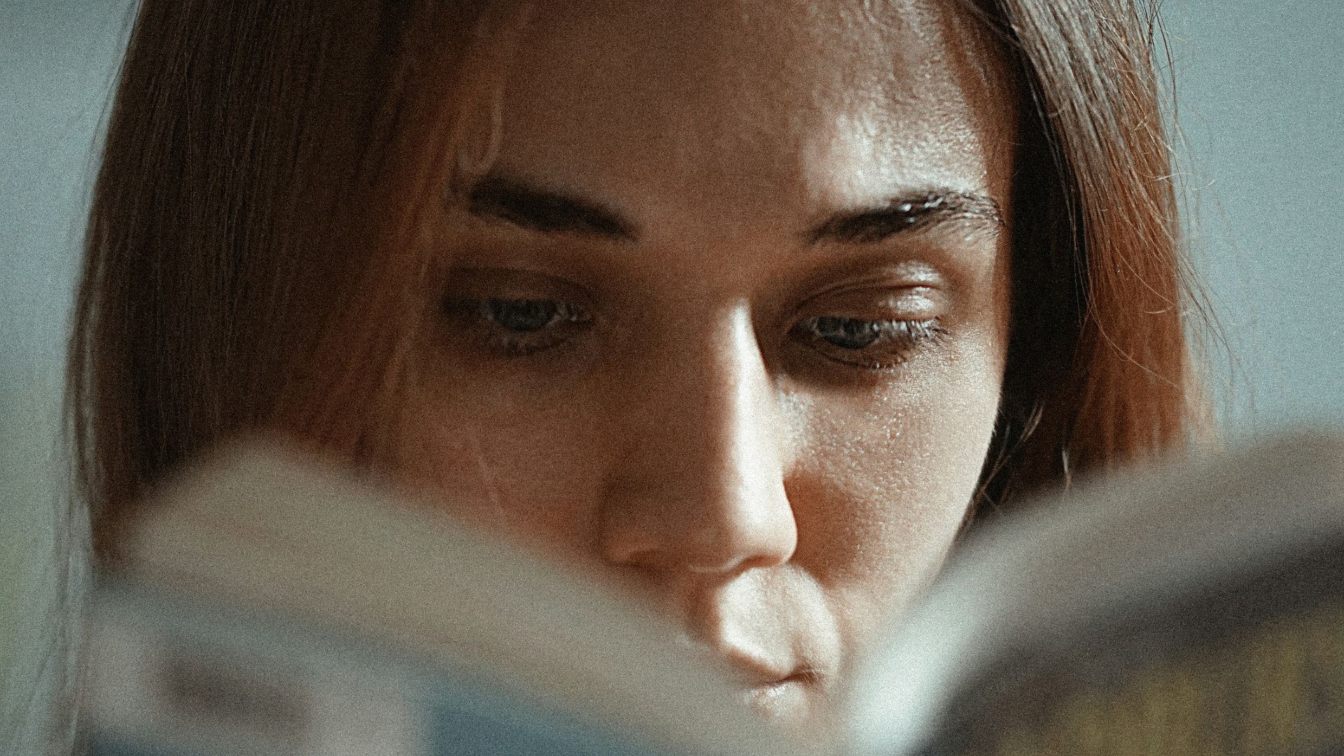 woman holding magazine with womans face