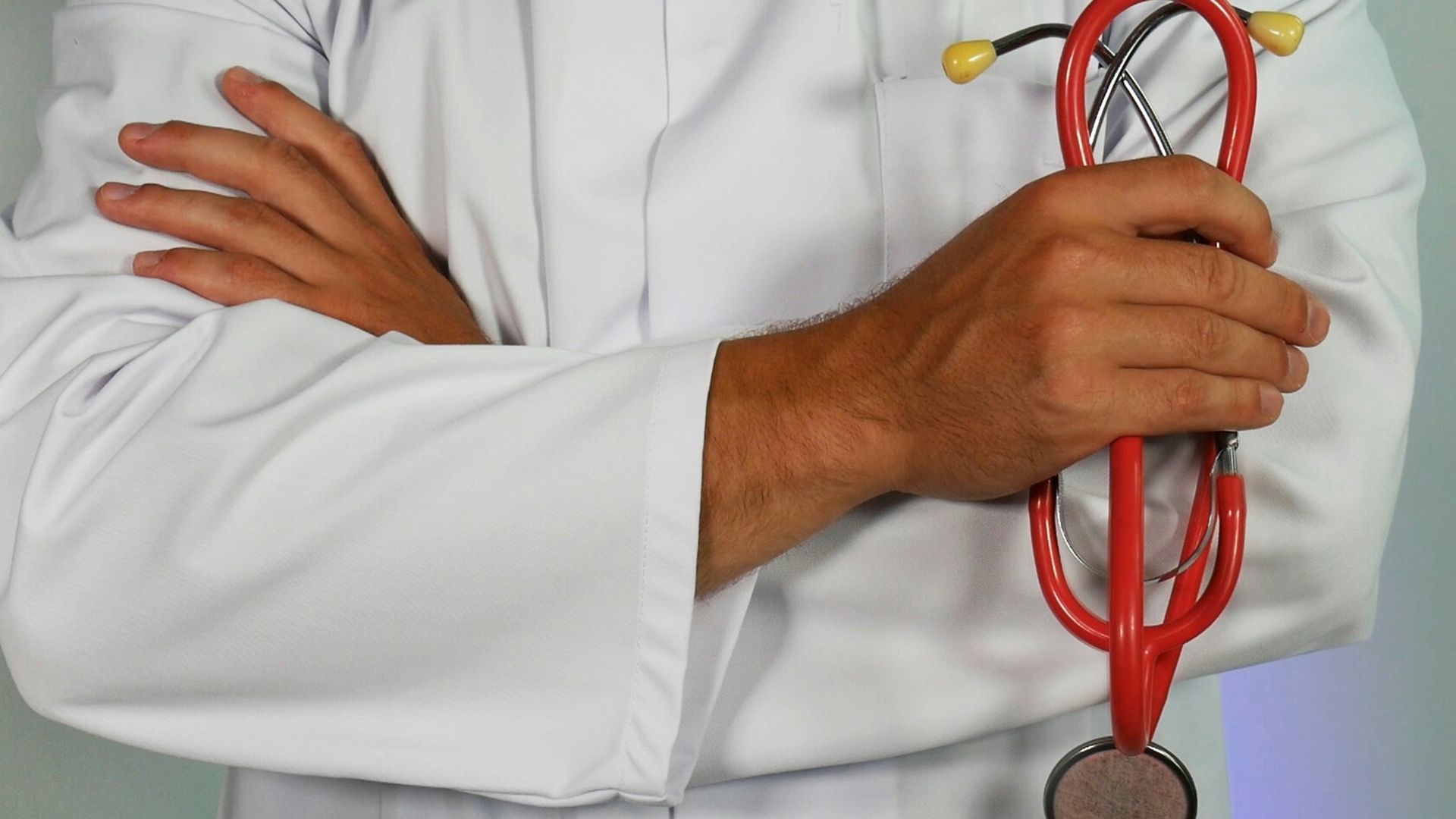 doctor holding red stethoscope