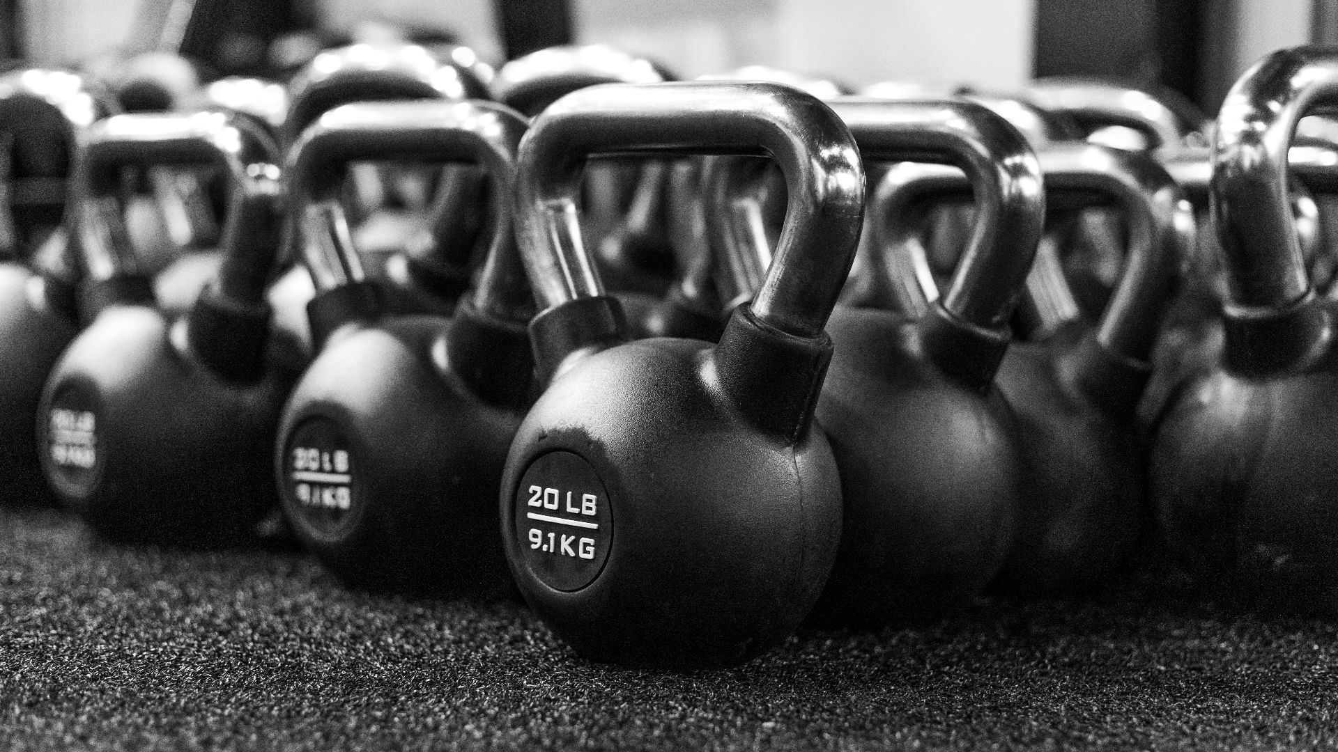 a row of kettles lined up in a gym