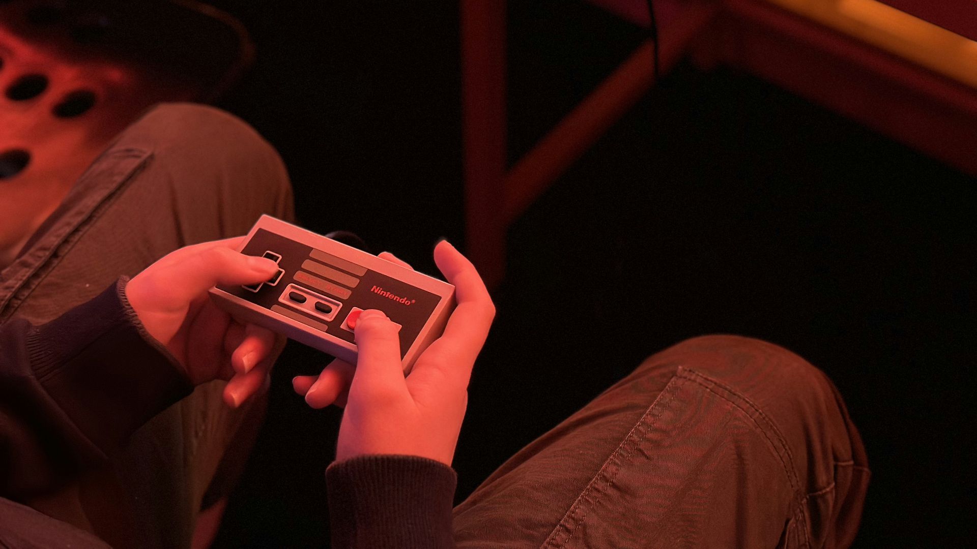 a person sitting on the floor playing a video game