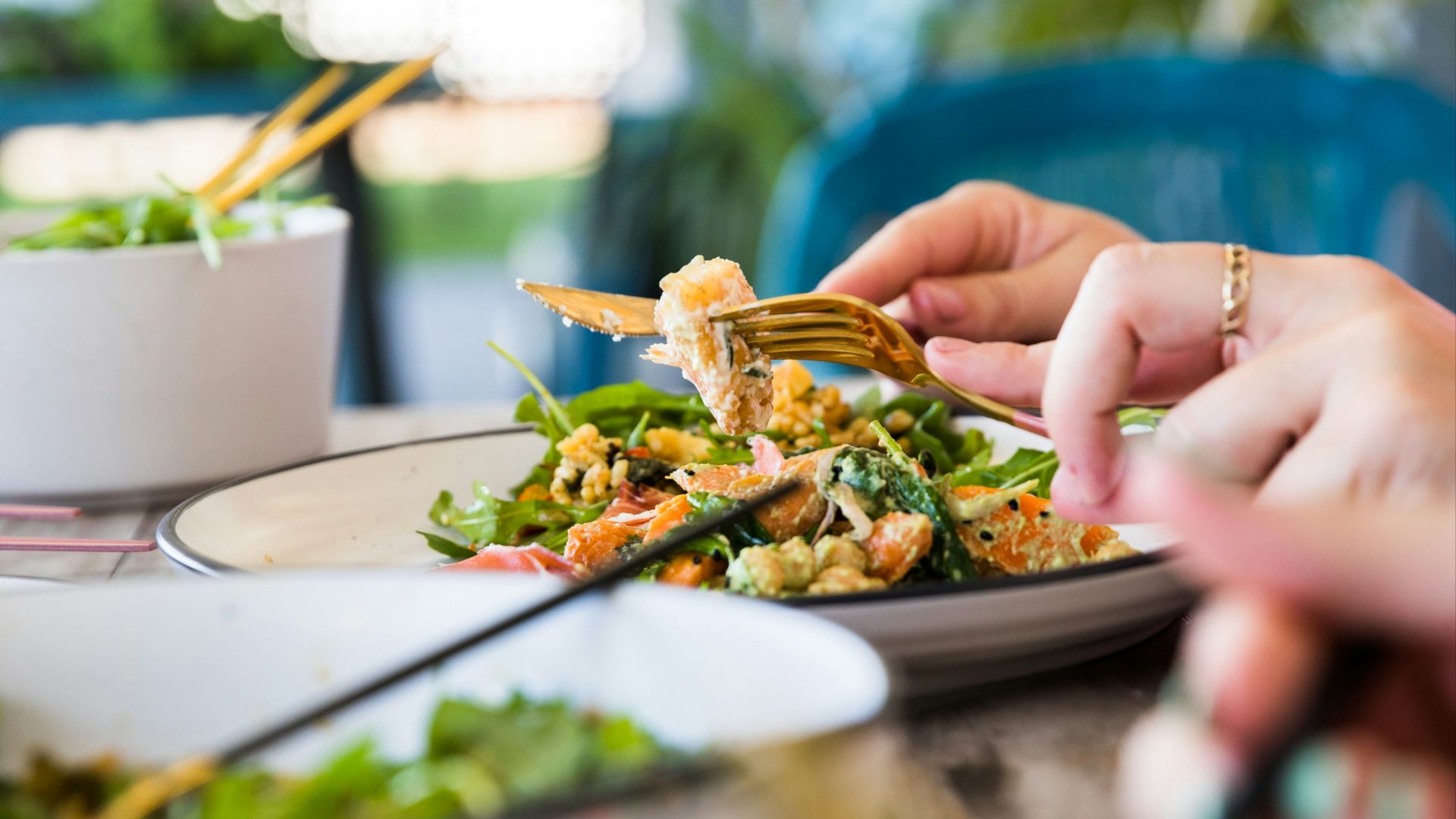 person holding brown and green vegetable dish