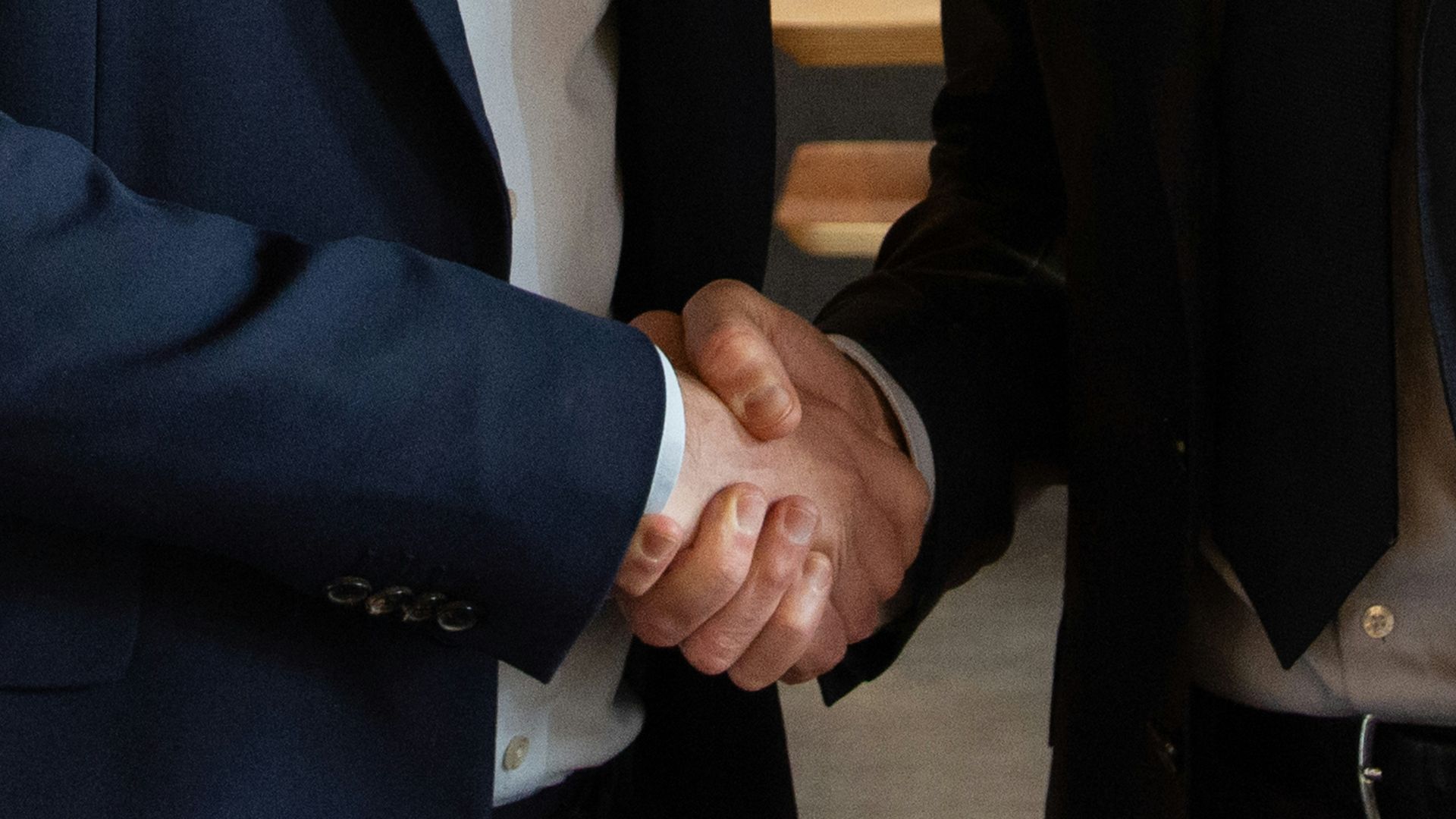 Business partners shake hands, making a deal.