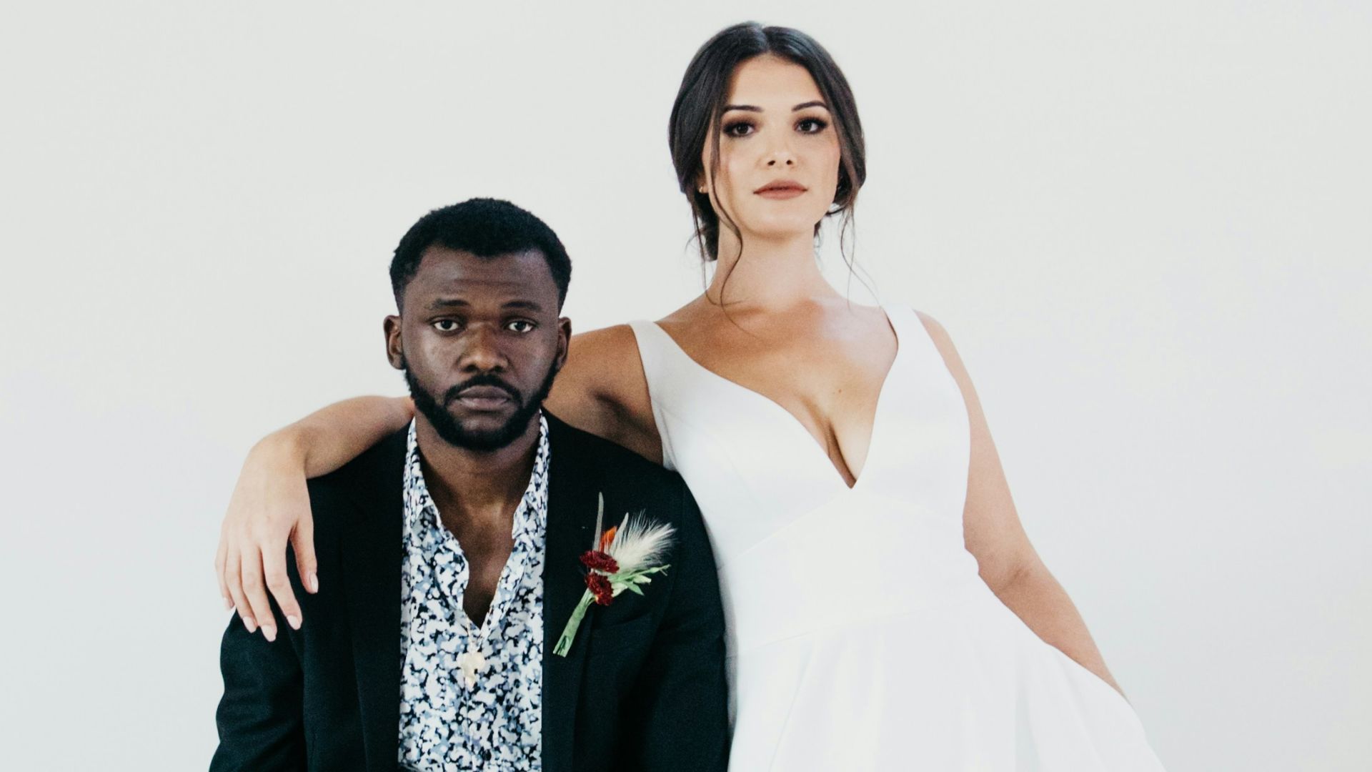 woman in white wedding gown holding bouquet of flowers