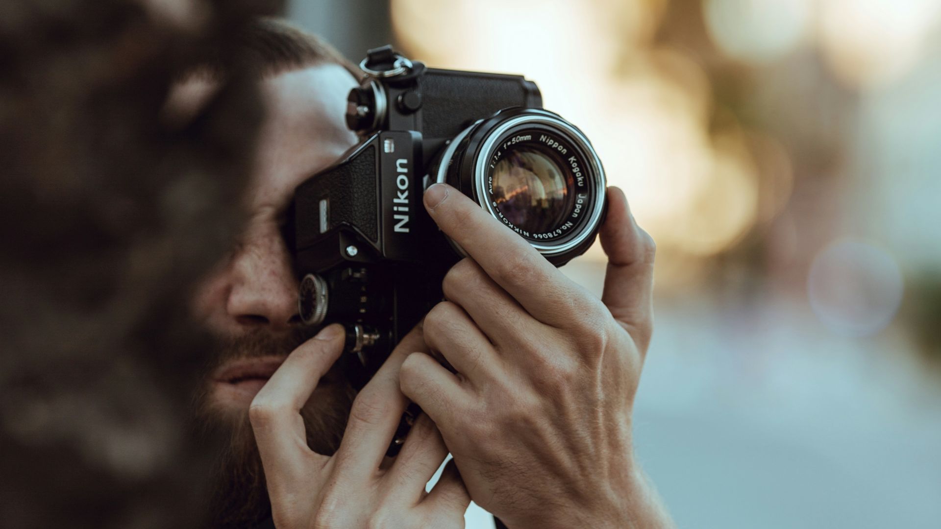 person using black Nikon DSLR camera