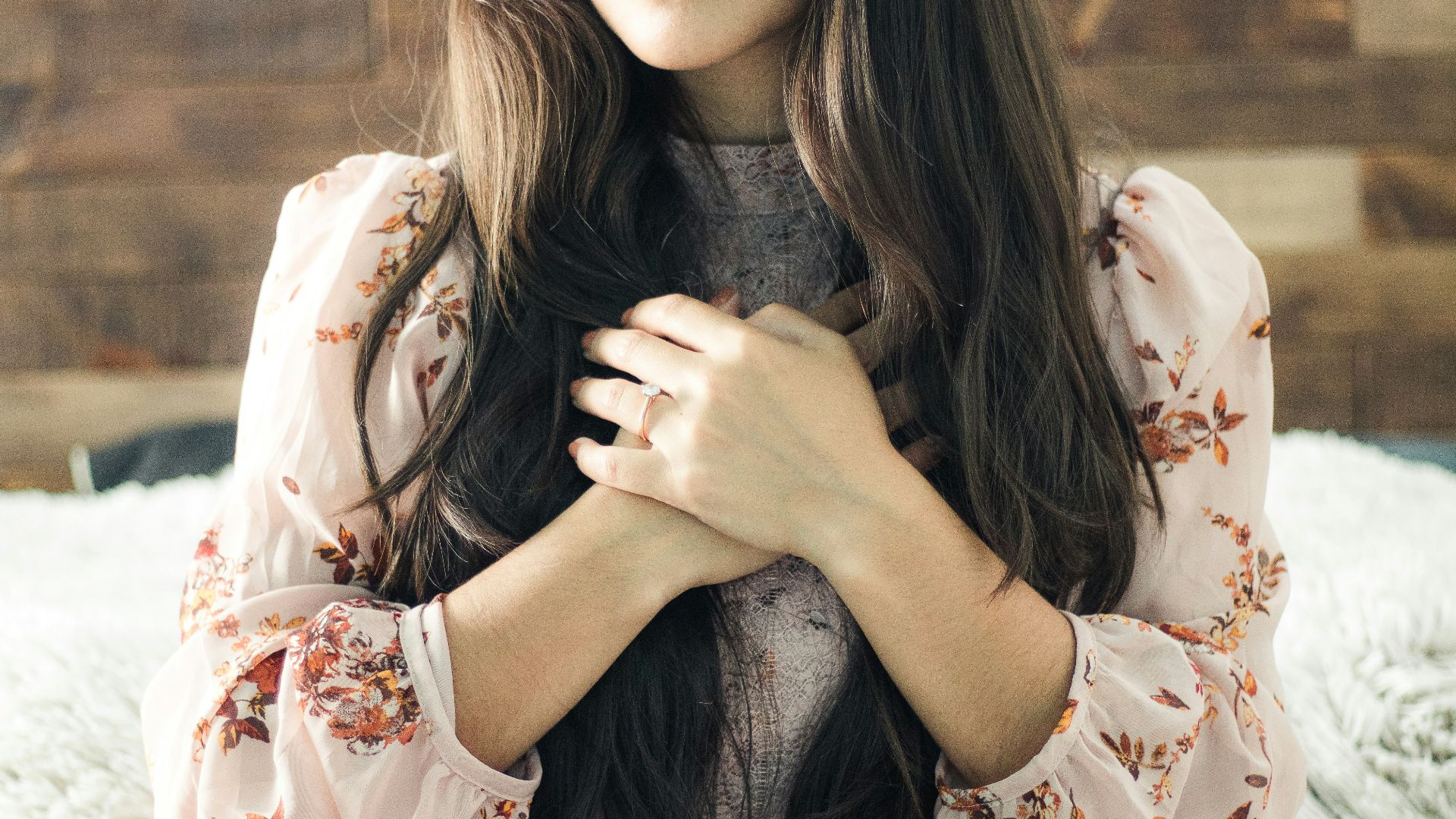 woman in white and red floral long sleeve shirt