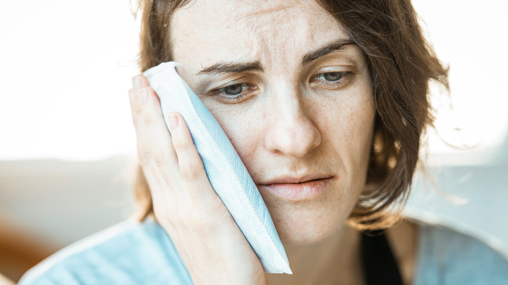 woman in black tank top holding white textile