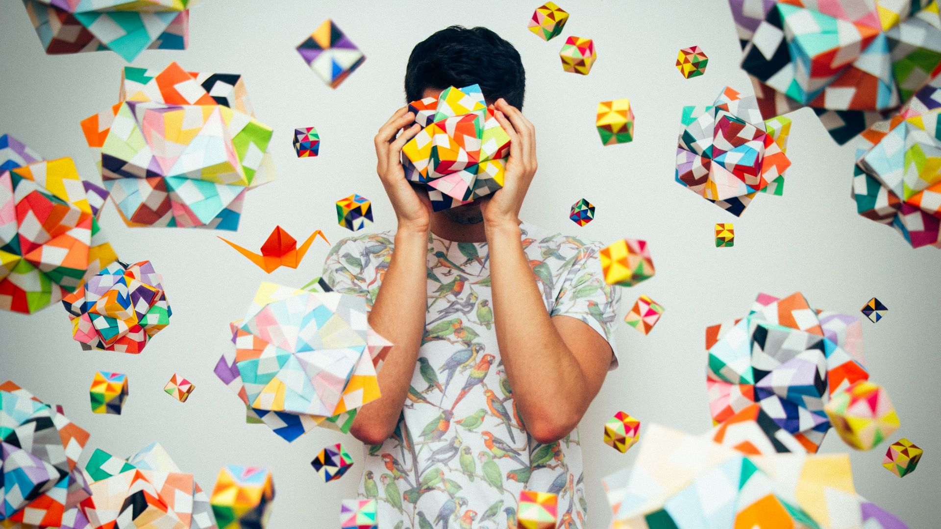 woman in white blue and red floral dress covering her face with white blue and yellow