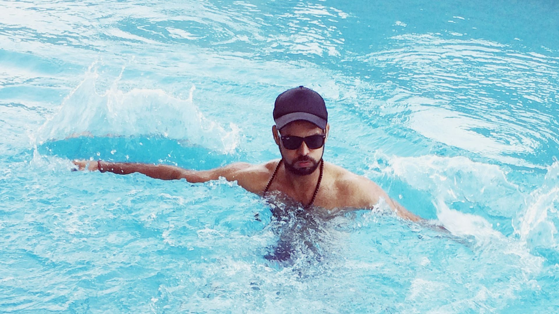 woman in black swimming goggles in water