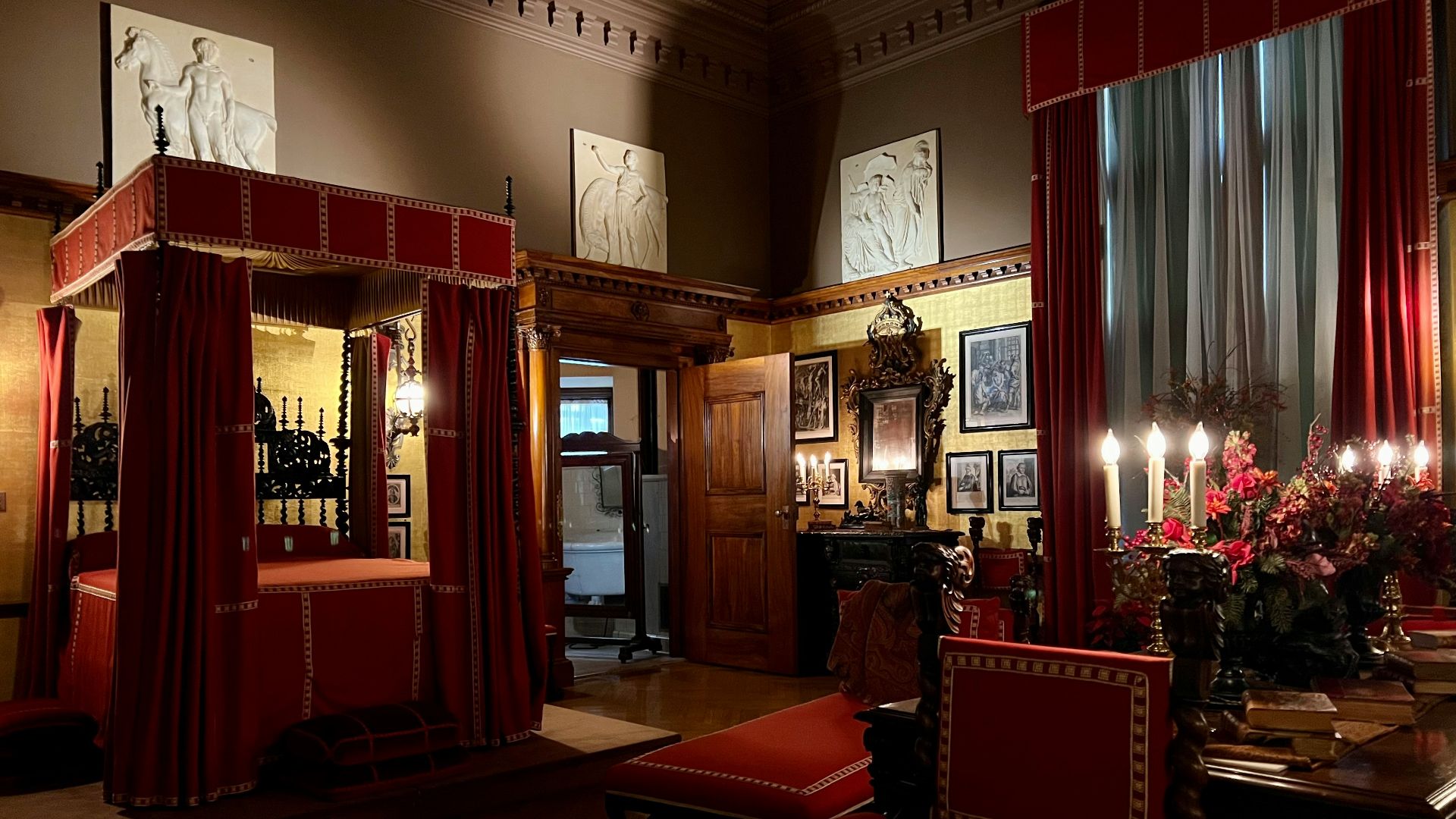 a room with red curtains and a table with chairs