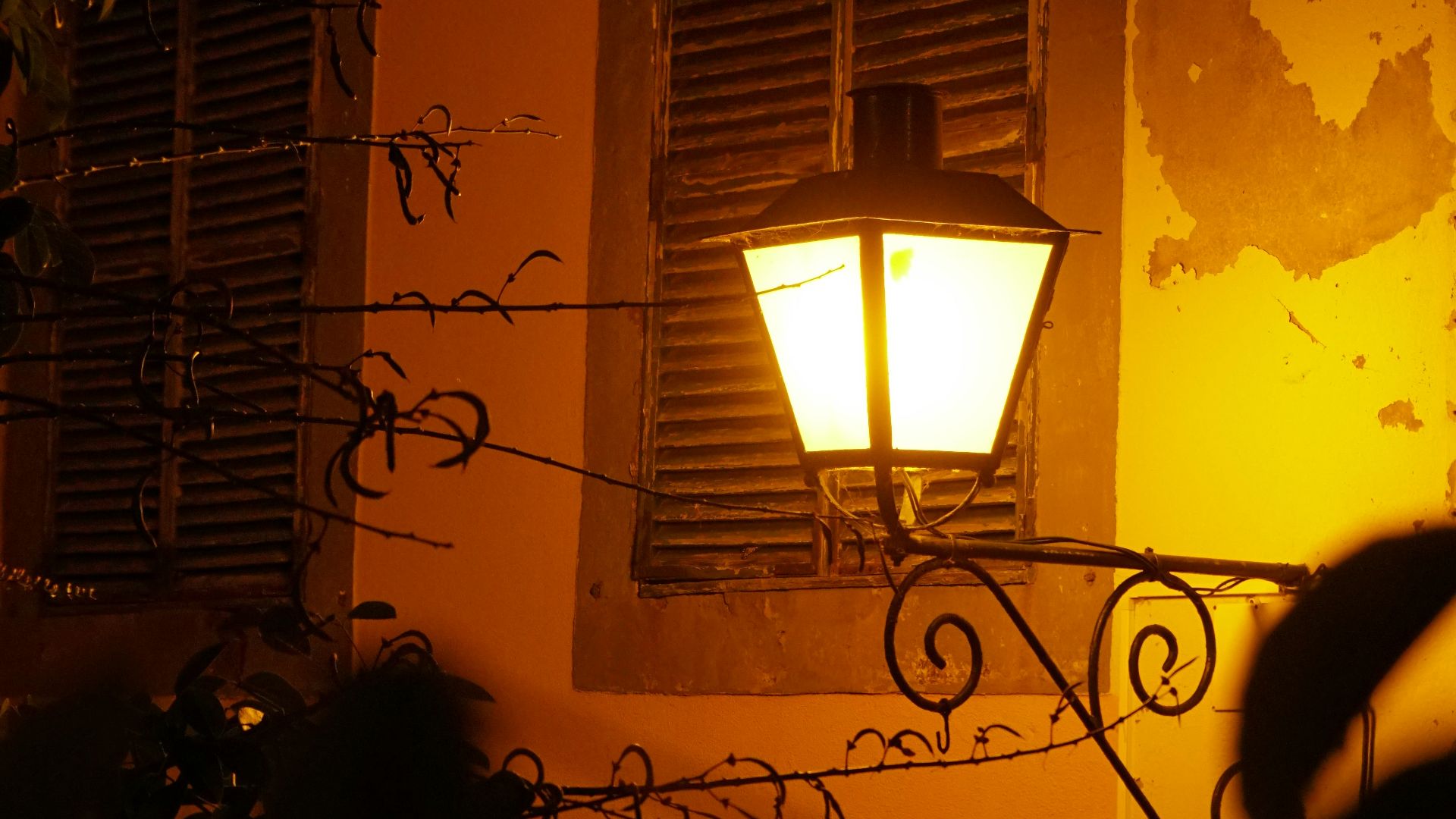 a street light in front of a building at night
