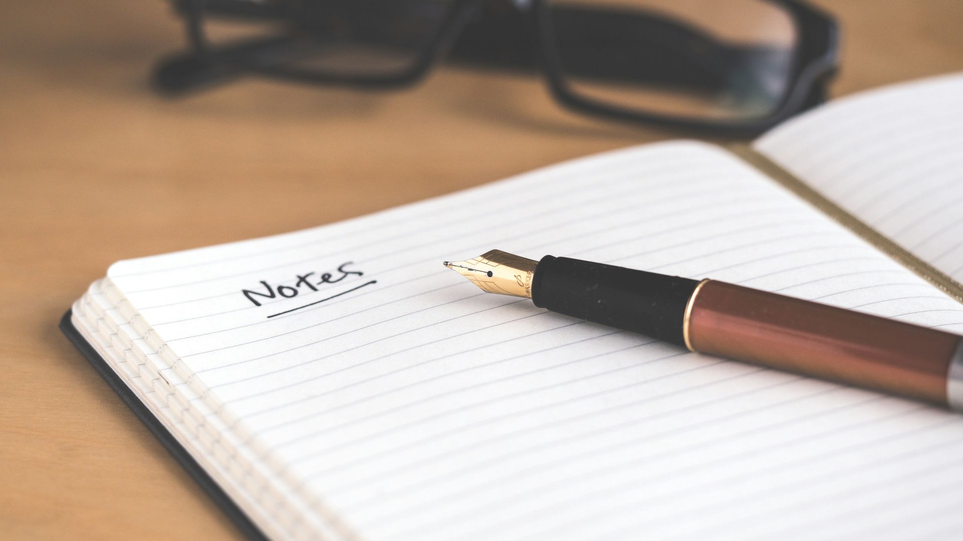 brown fountain pen on notebook