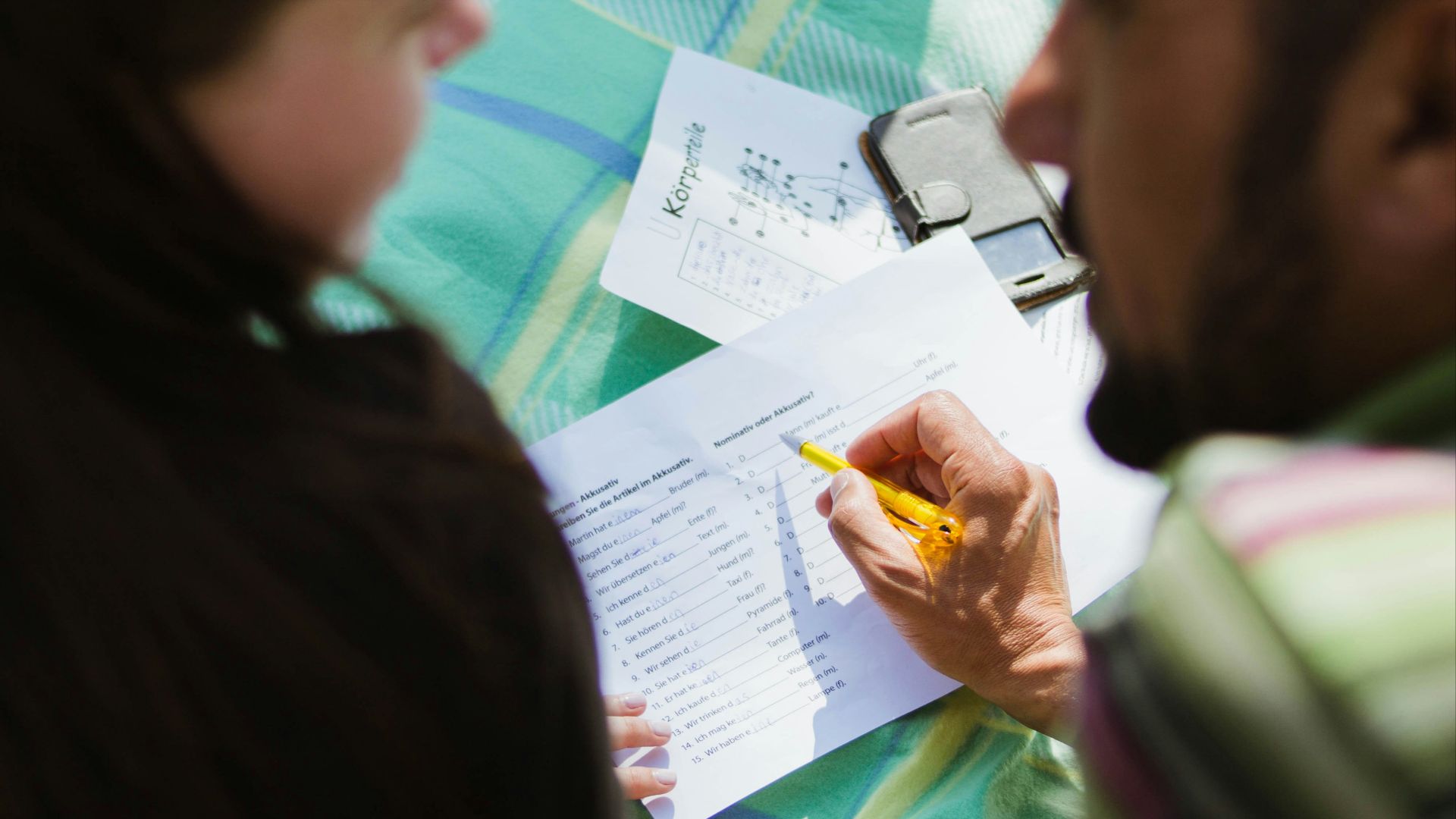 man in black shirt sitting beside woman in gray shirt